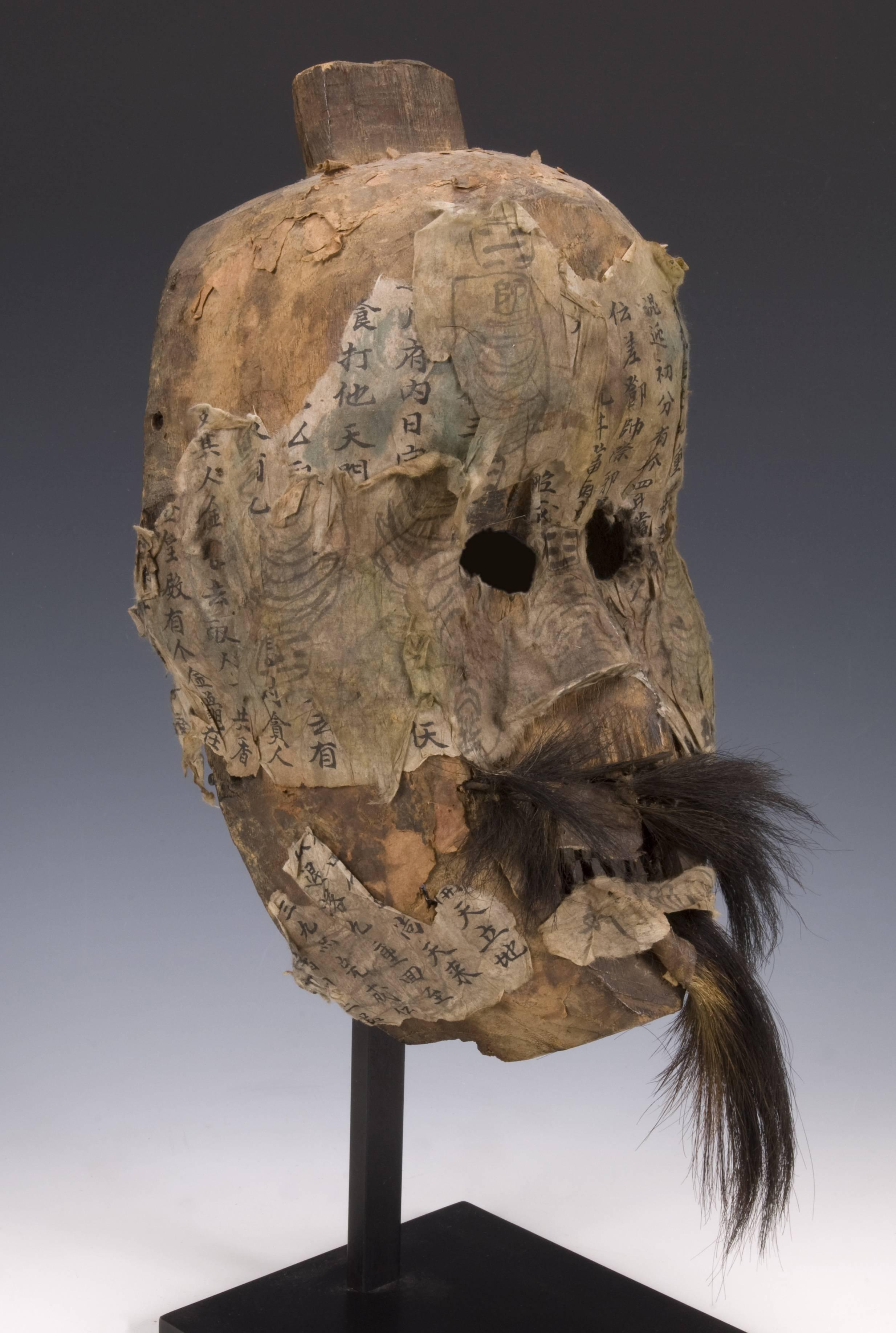 Offered by ANDRES MORAGA
Yao Shaman's Mask
Guizhou Province, China
Late 19th or early 20th century
Covered inside and out with printed and handwritten protective prayers
It comes on a custom steel stand.