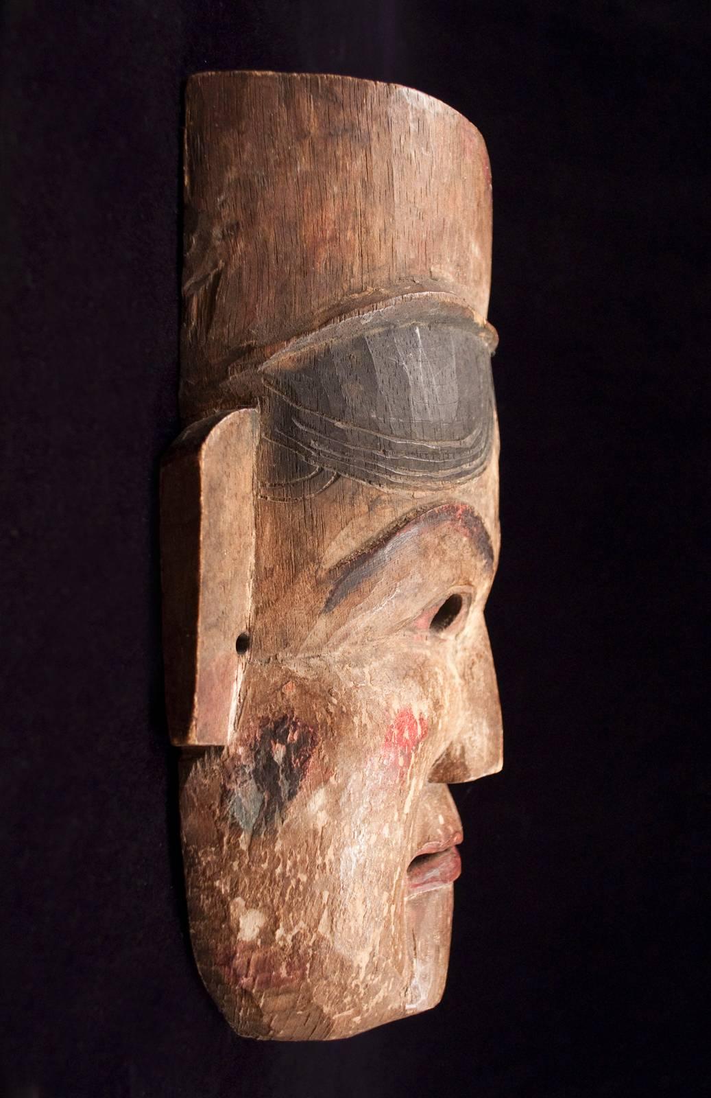 Late 19th-early 20th century wood theater mask from Nepal

The tone of the emotion conveyed with this very expressive mask, which was used in local theatrical enactments, likely changed with the tilt of the head, lighting and context. Whether being
