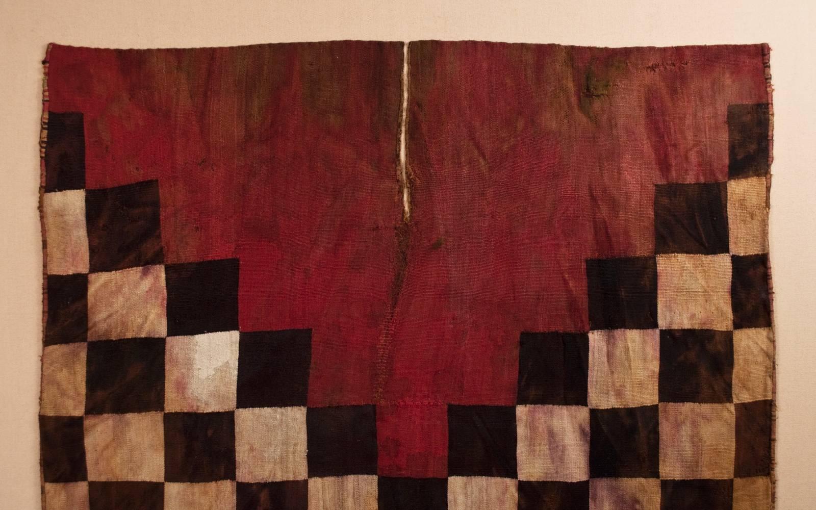 Offered by Zena Kruzick
15th century checkerboard warrior's tunic from the Inca Culture, Peru

The front and back of this striking warrior's tunic are mounted together, which minimizes a few holes, as the back fills in the gaps in the