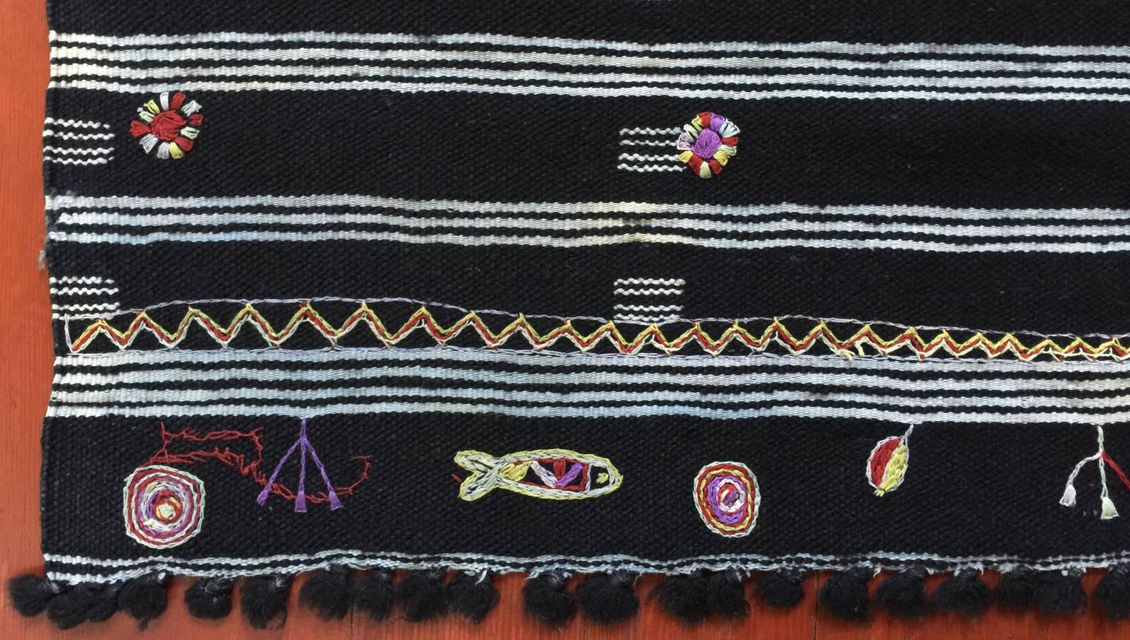 Mid-20th century tribal baknough (woman's head covering), Chott Oulad Amar, Tunisia.

This is an unusual baknough from a very small area on the Tunisian coast, made even more special by the talismanic embroidery at both ends. Excellent condition.