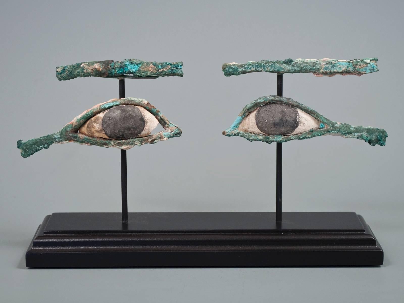 Offered by Zena Kruzick.
Ancient Egyptian bronze and limestone eyes from a wooden sarcophagus.
8.75