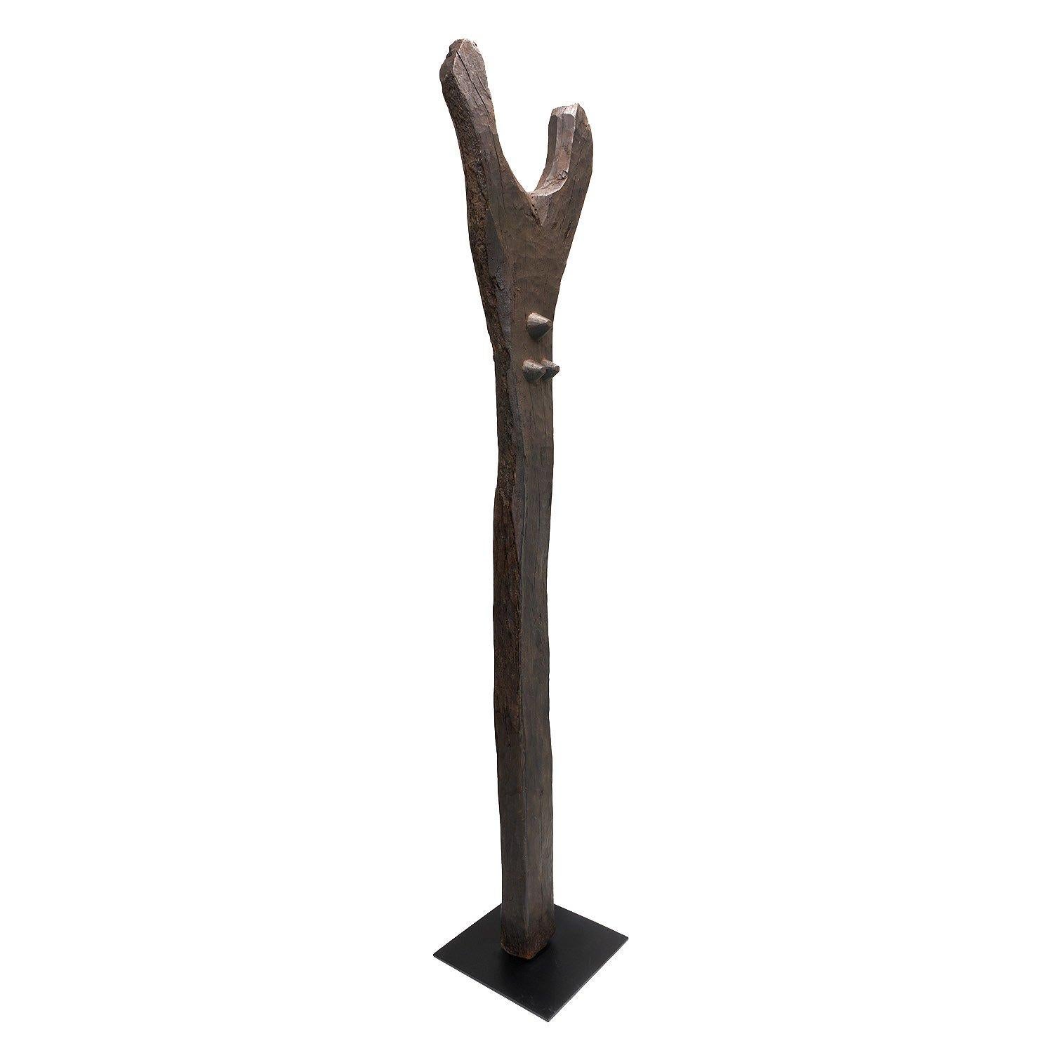 With a textured, slightly eroded patina, Malians used this tall house post to support a major beam in a structure. Carved from a naturally forked tree, these tall sculptural supports exude an uplifting, majestic quality.

Mounted on a custom display