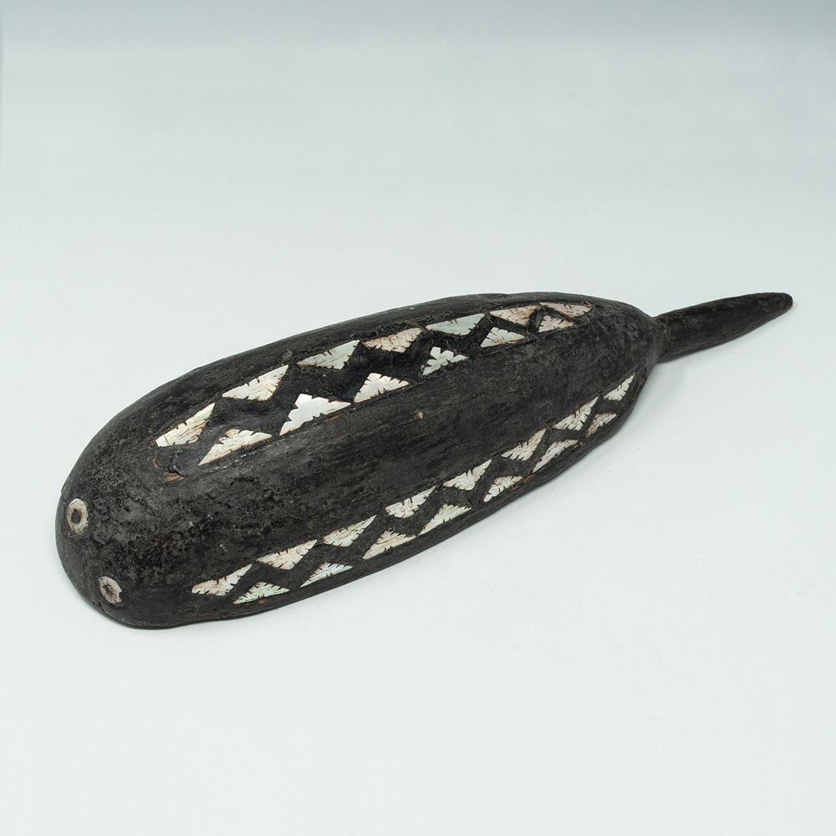 Early 20th Century Wood and Shell Scoop, Solomon Islands

A small scoop in the shape of a whale, with three rows of inlaid notched shell triangles and three circular shell eyes. Nice encrusted patina and all the inlays are intact.
1.75 by 9 by 2.75