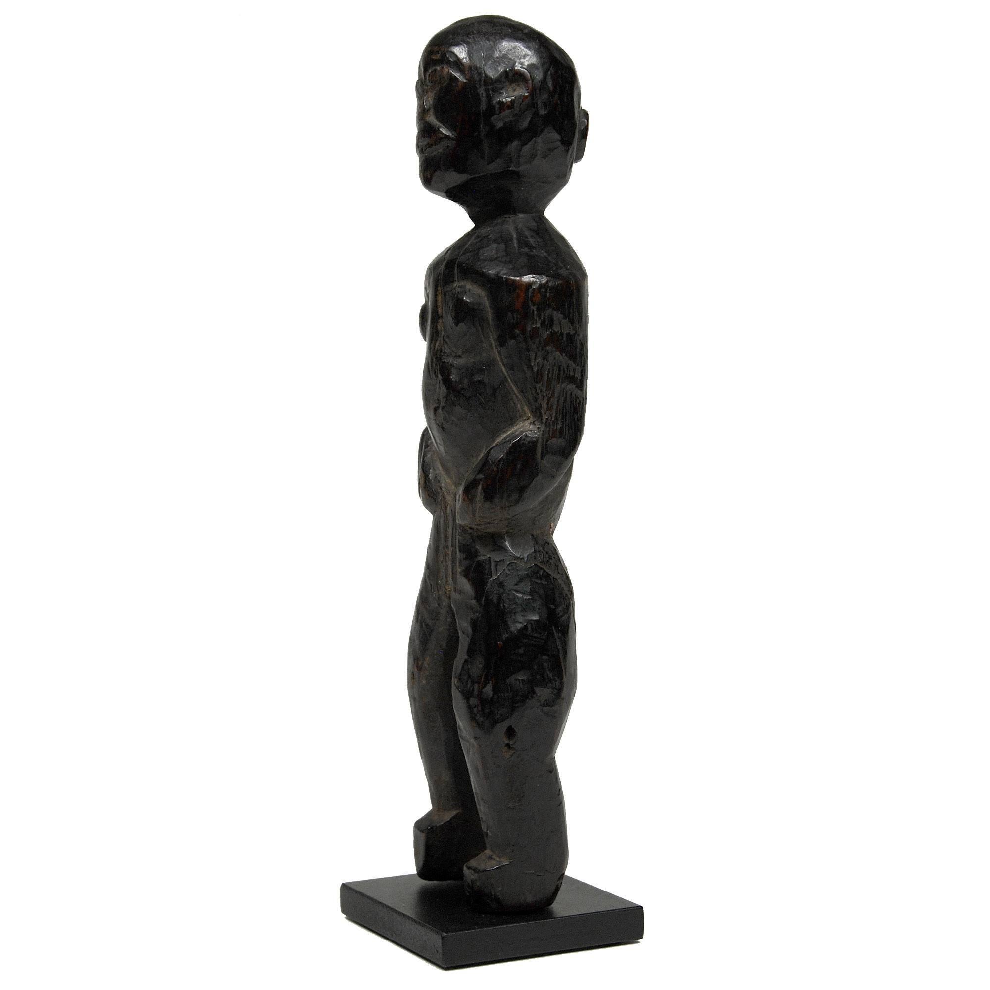 Early 20th Century Simply Carved Wood Figure from Nepal

The figure has a dark patina and the edges are smooth from handling. Carved in a naive style typical for the region. 