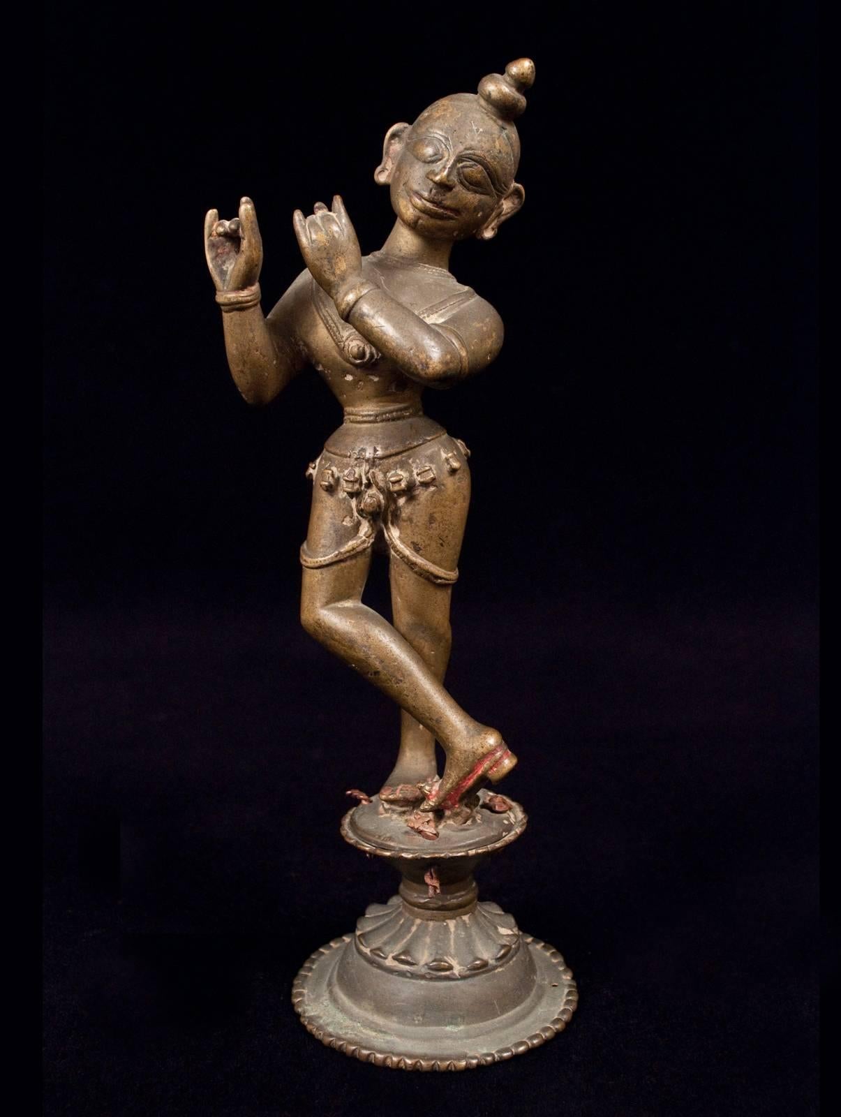 16th Century Krishna (Venugopala) Bronze Figure Playing the Flute from Orissa, India

The Venugopala form of Krishna playing the flute is to Vaishnavite iconography what Nataraja is to the Shaivites: The piece de resistance. Here he stands in his