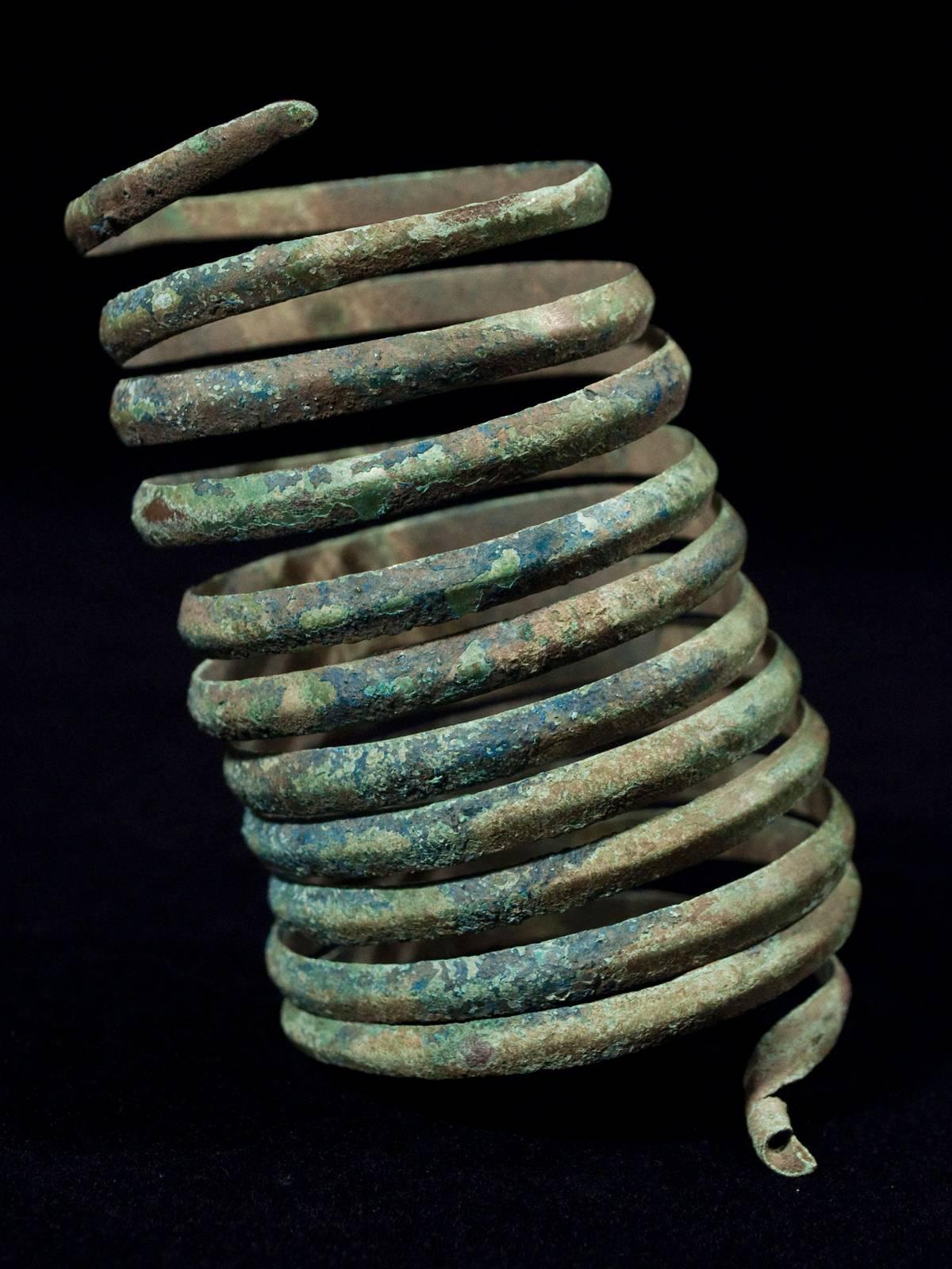 Offered by Zena Kruzick.
Ancient near eastern coiled bronze bracelet.

Measures: 4.75" (12 cm) high, 7.25" (21 cm) upper circumference, 8.75" lower circumference.
Late 2nd-early 1st century B.C.
Formed from a continuous band with