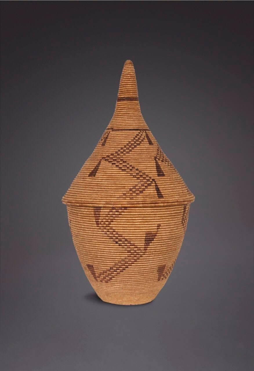 A very large Tutsi basket, called an Ibiseke, used for storing grains.
The composition incorporates several known motifs yet it shows an idiosyncratic touch and imaginative reworking of the communal stock of geometric and linear forms that