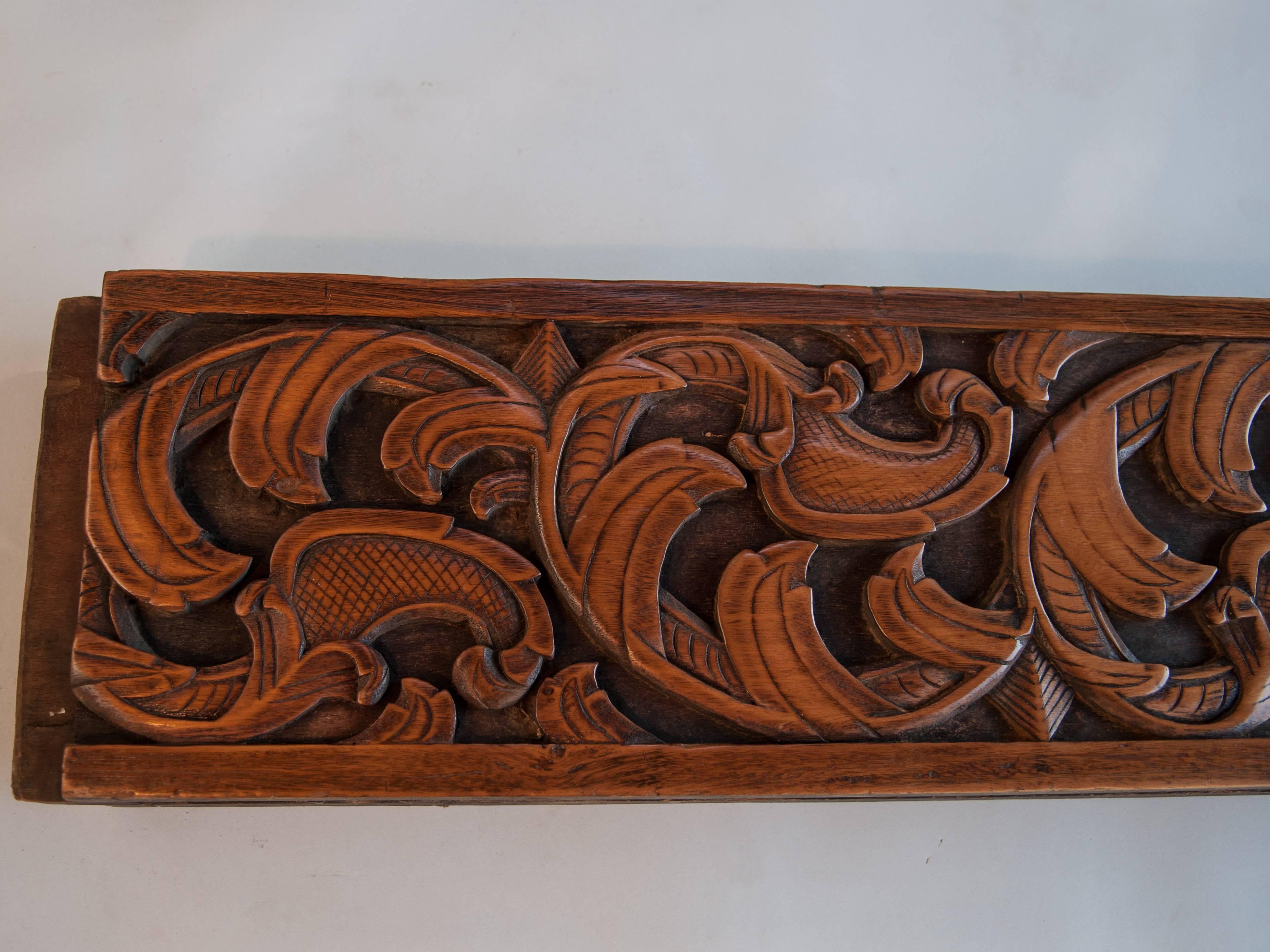 Hand-carved wooden architectural panel from the Minangkabau of West Sumatra, Mid-Late 20th century; incorporating a scroll leaf pattern, 