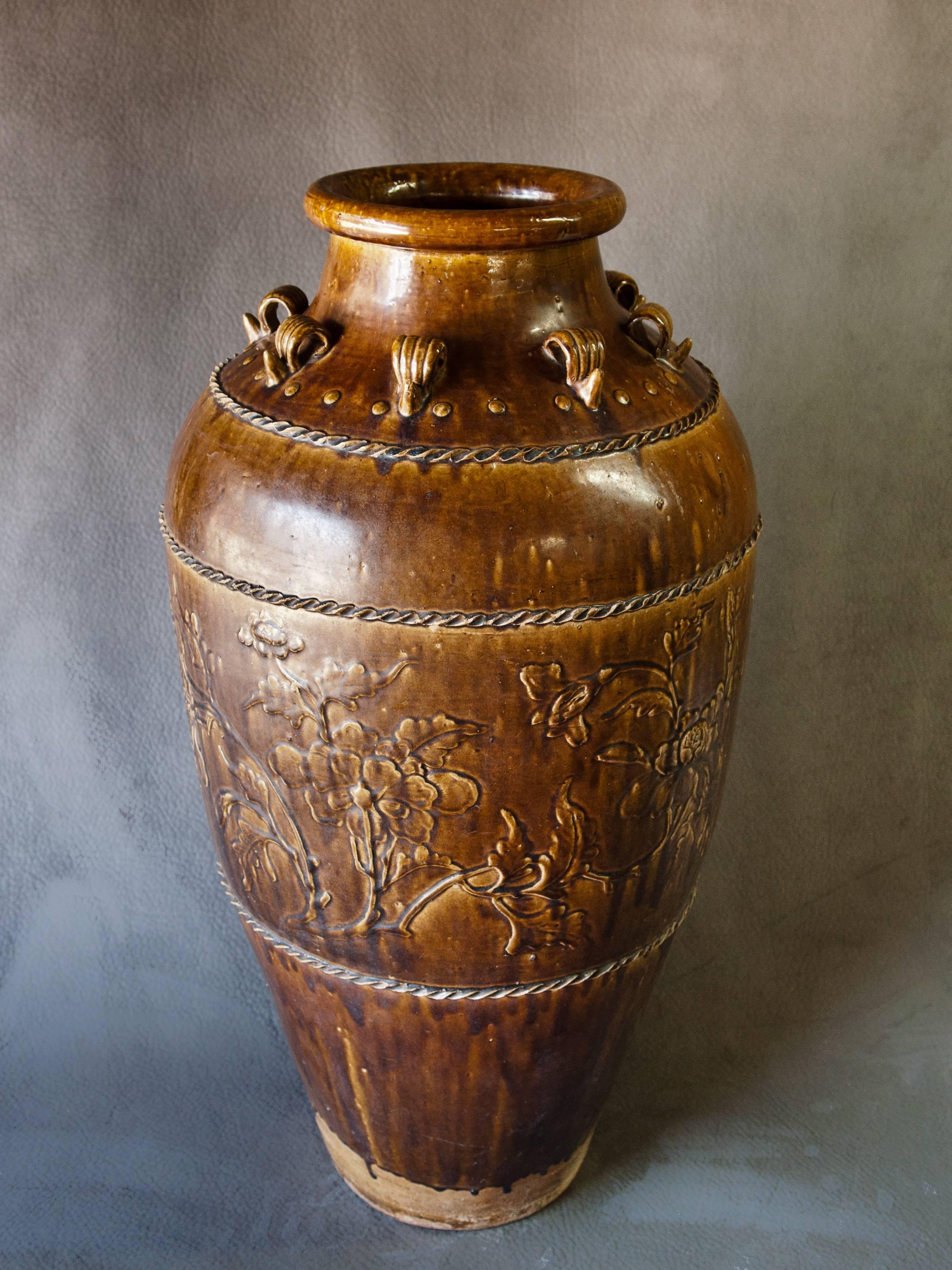 Tall Ming Dynasty Storage Jar. Martaban Ware. Found in Laos. Floral Design.
Tall brown glazed storage jar found in Laos but manufactured in southern China most probably during the Ming Dynasty. The jar is in excellent condition with a floral design