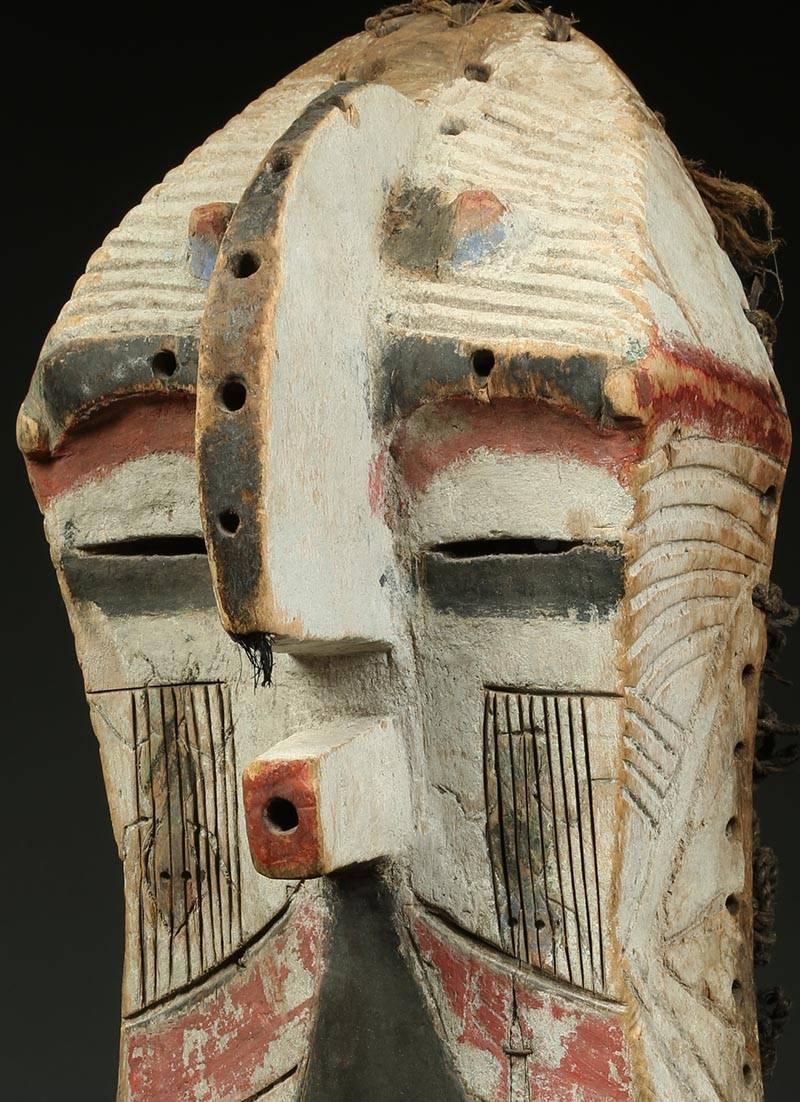 Songye Luba Kifwebe Tribal wood mask, with white, red and black Africa, Congo

This early to mid-20th century dance mask shows great design, color and character from age and use. Projecting nose and mouth with geometric incised designs, old chips,