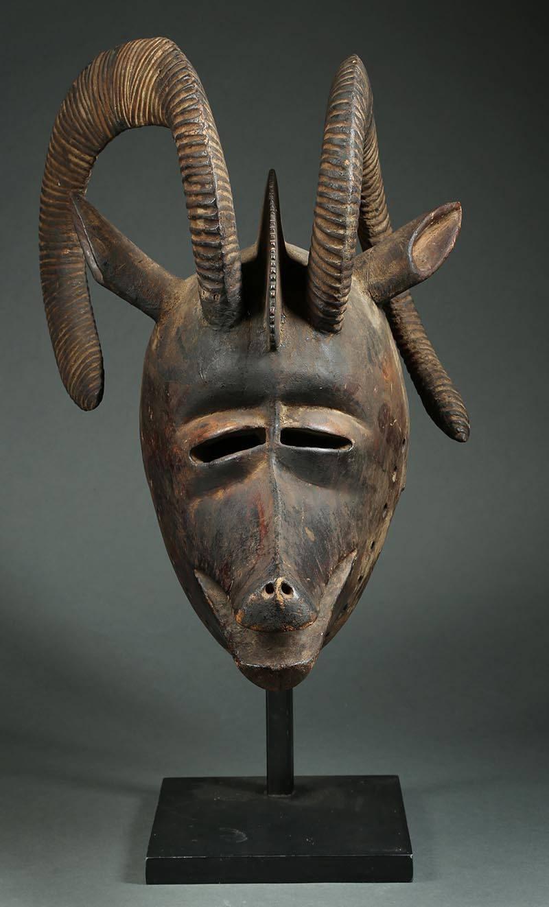 African bobo (Burkina Faso) large tribal ram helmet mask with curved horns

Large hardwood helmet mask representing a ram. Lively asymmetrical carved horns encircle the top of the head. Very similar mask published by Christopher Roy, and another
