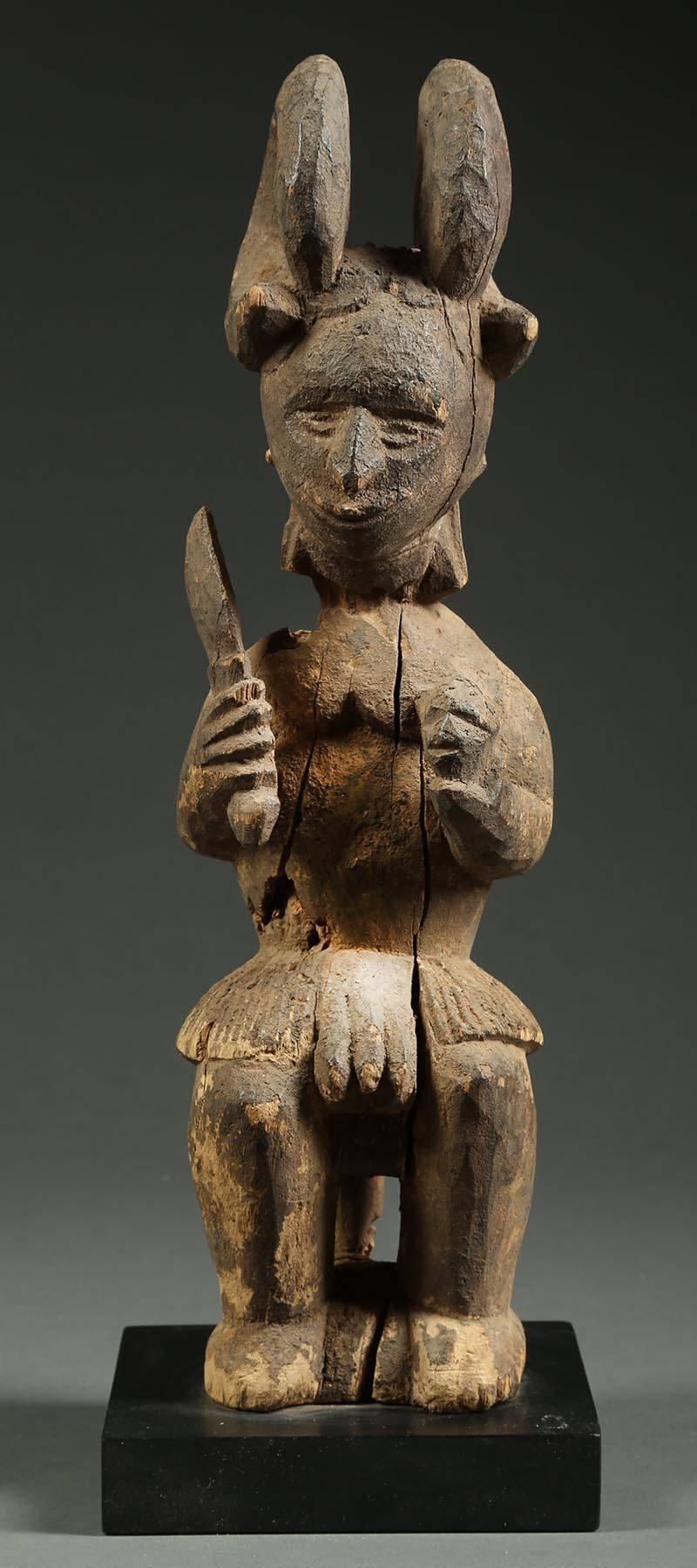 Igbo tribal seated Ikenga figure with sword and head Africa, Nigeria

Classic Ikenga Shrine figure seated on a stool with curved horns encircling his head. Areas of erosion, weathered surface and insect damage from age. Ex- Tom Slater, ex- private