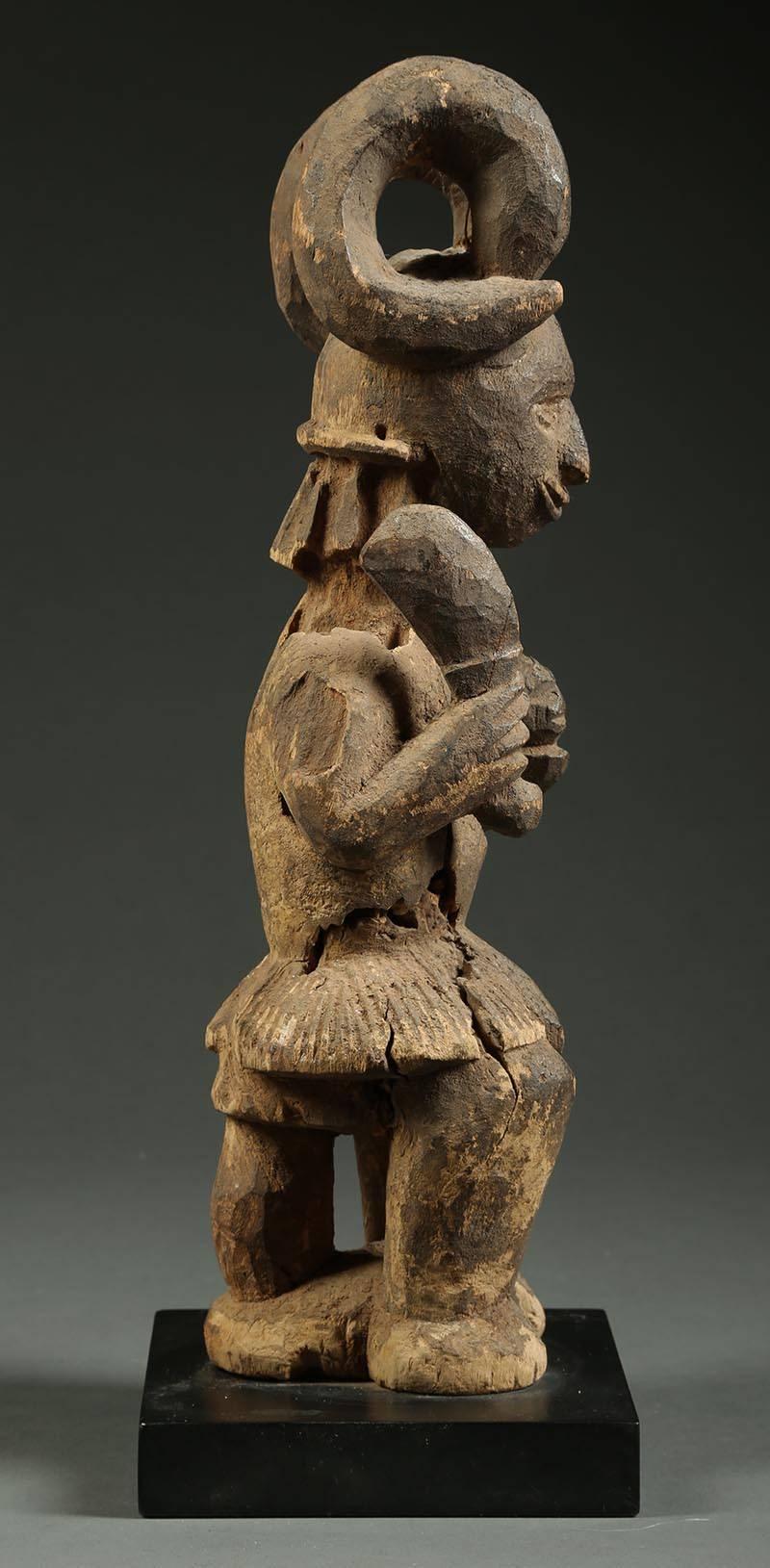 Hand-Carved Igbo Tribal Seated Ikenga Figure with Sword and Head Africa, Nigeria