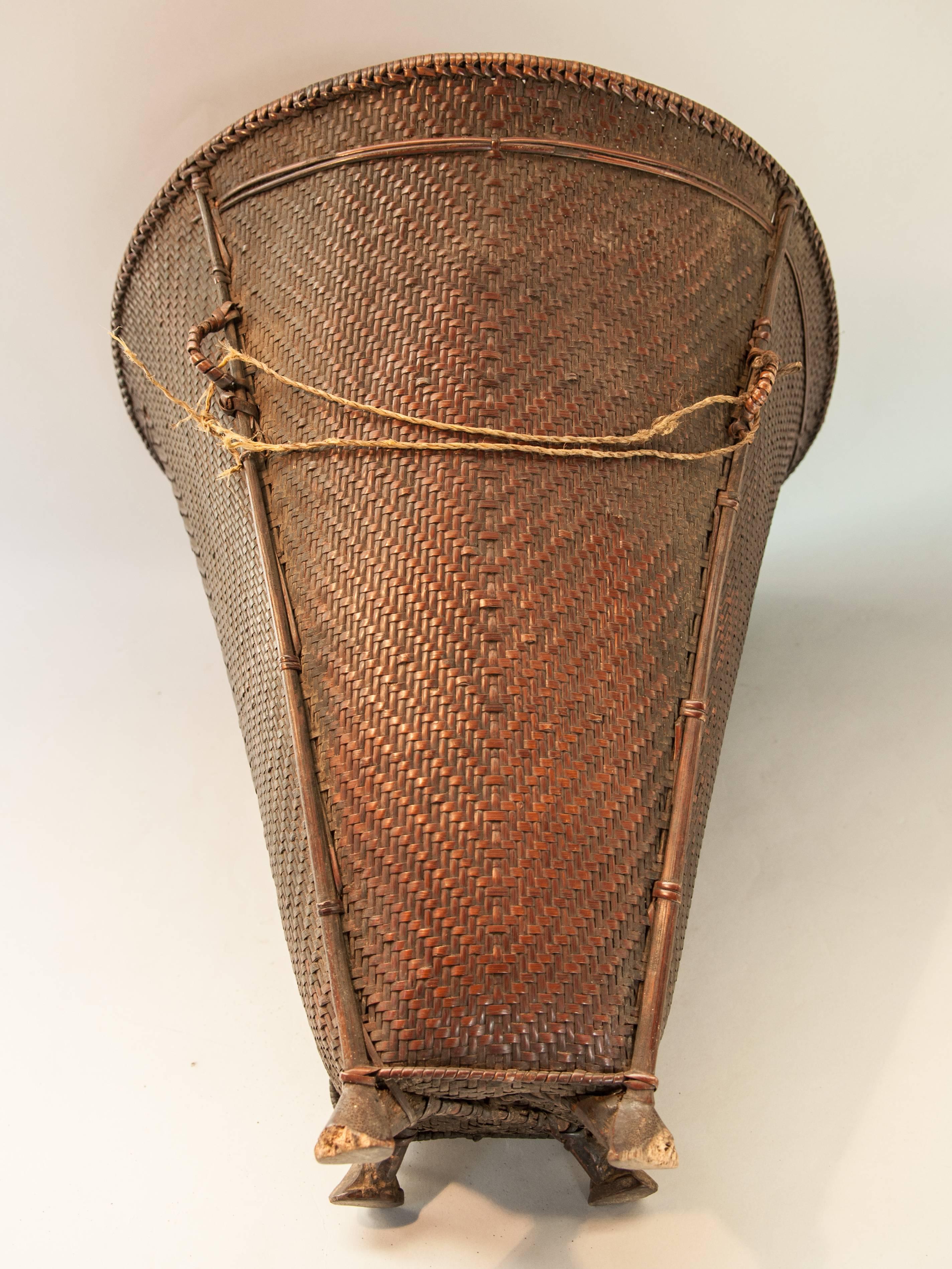 Tribal Carrying Basket with Wooden Feet Naga of Ne India, Mid-20th Century In Fair Condition In Point Richmond, CA