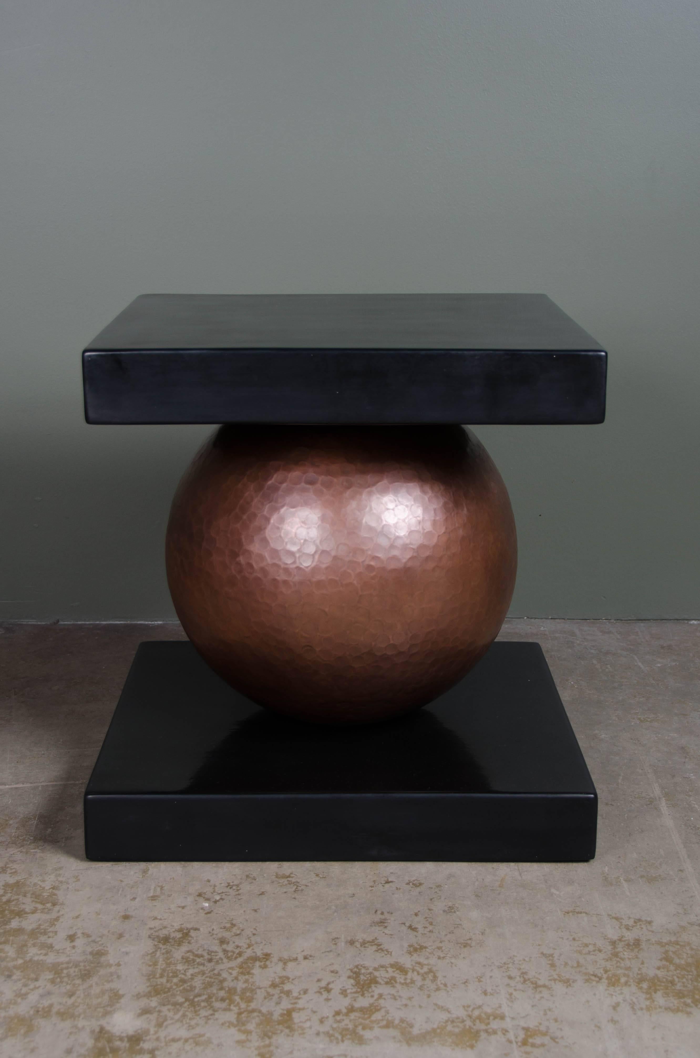 Sphere table
antique copper
black lacquer
hand repoussé
limited edition side table.

Lacquer is a technique that dates back to the Shang dynasty, circa 1600-1100 B.C. These pieces are made with at least 60 coats of organic lacquer. Each layer of