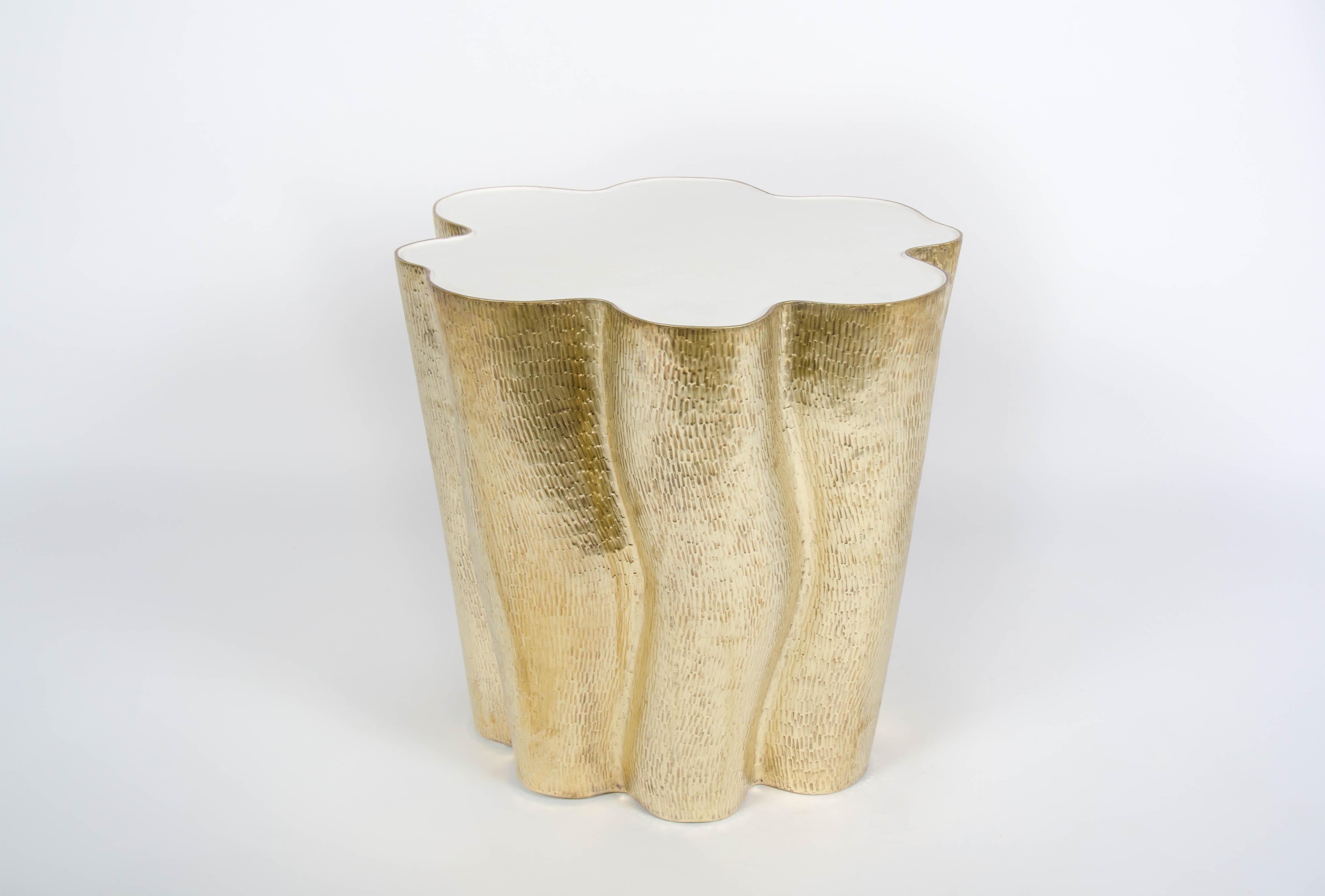 Ji Guan Side Table w/ Cream Lacquer
Brass 
Hand Repoussé
Cream Lacquer
Limited Edition
Contemporary

Repoussé is the traditional art of hand-hammering decorative relief onto sheet metal. This technique involves using a hammer and various shaping