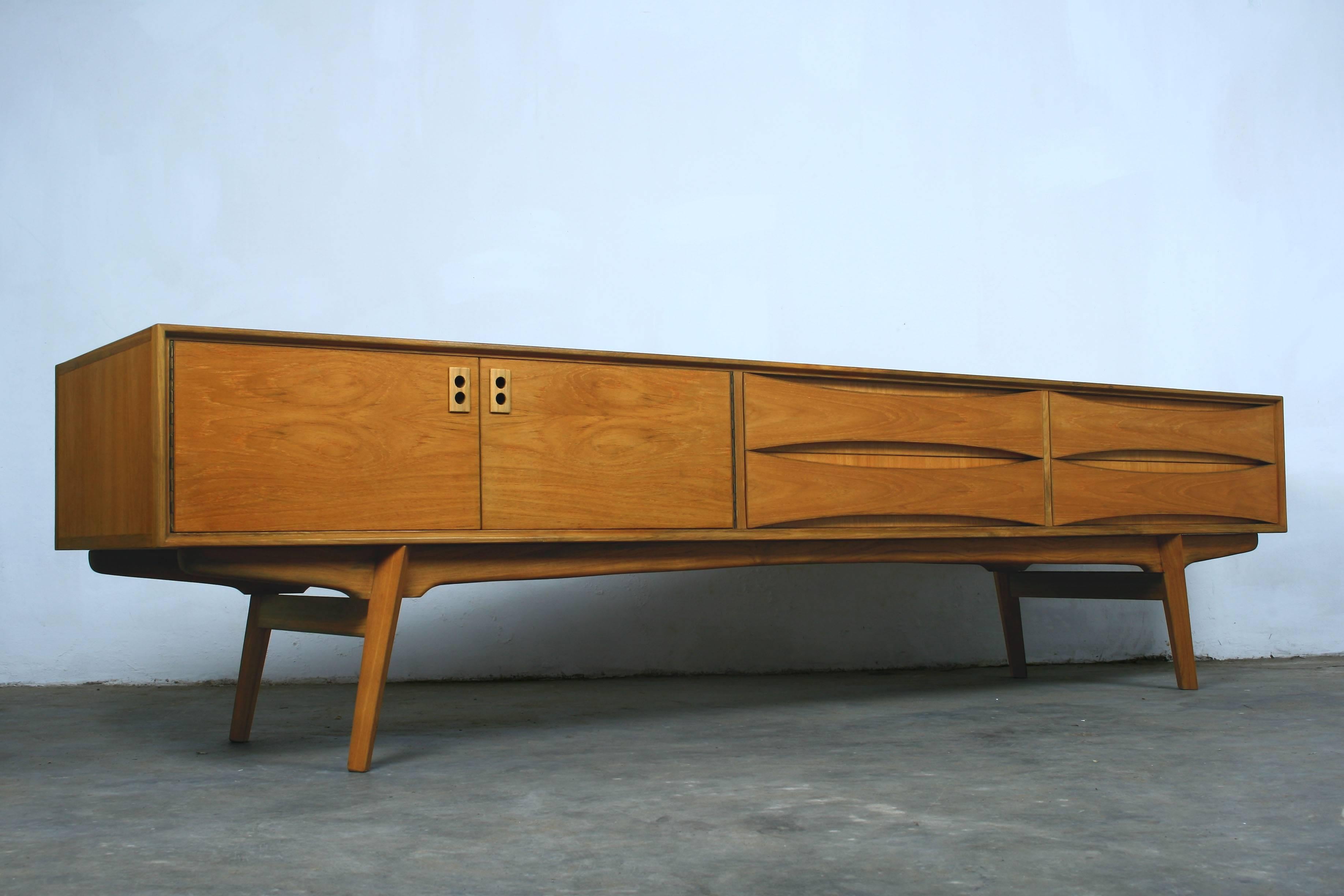 Extra low sideboard made in Belgium vintage retro Mid-Century.
Teak veneer and solid teak. Professionally refurbished.
Perfect as low cabinet for flat screen television.

  