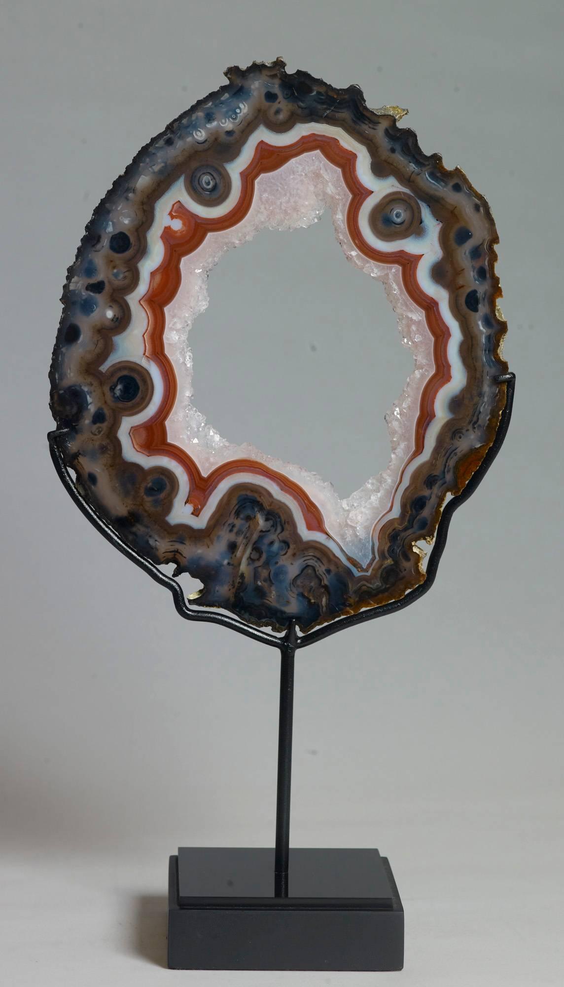 Very fine agate slice with a stunning red band and clear quartz crystals in the centre. Rio Grande do Sul, Brazil. Measures: 39 x 20 x 10 with stand.