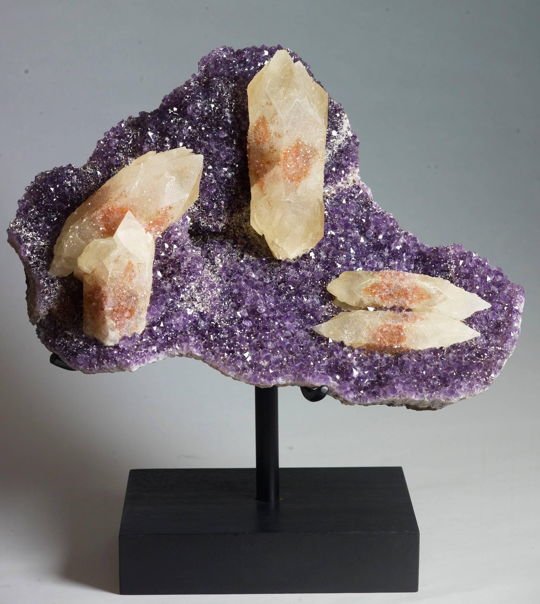 Beautiful bi-terminated calcite crystal with hematite included quartz, on a background of amethyst. Santa Catarina, Brazil. measures 43x40x23 with stand.