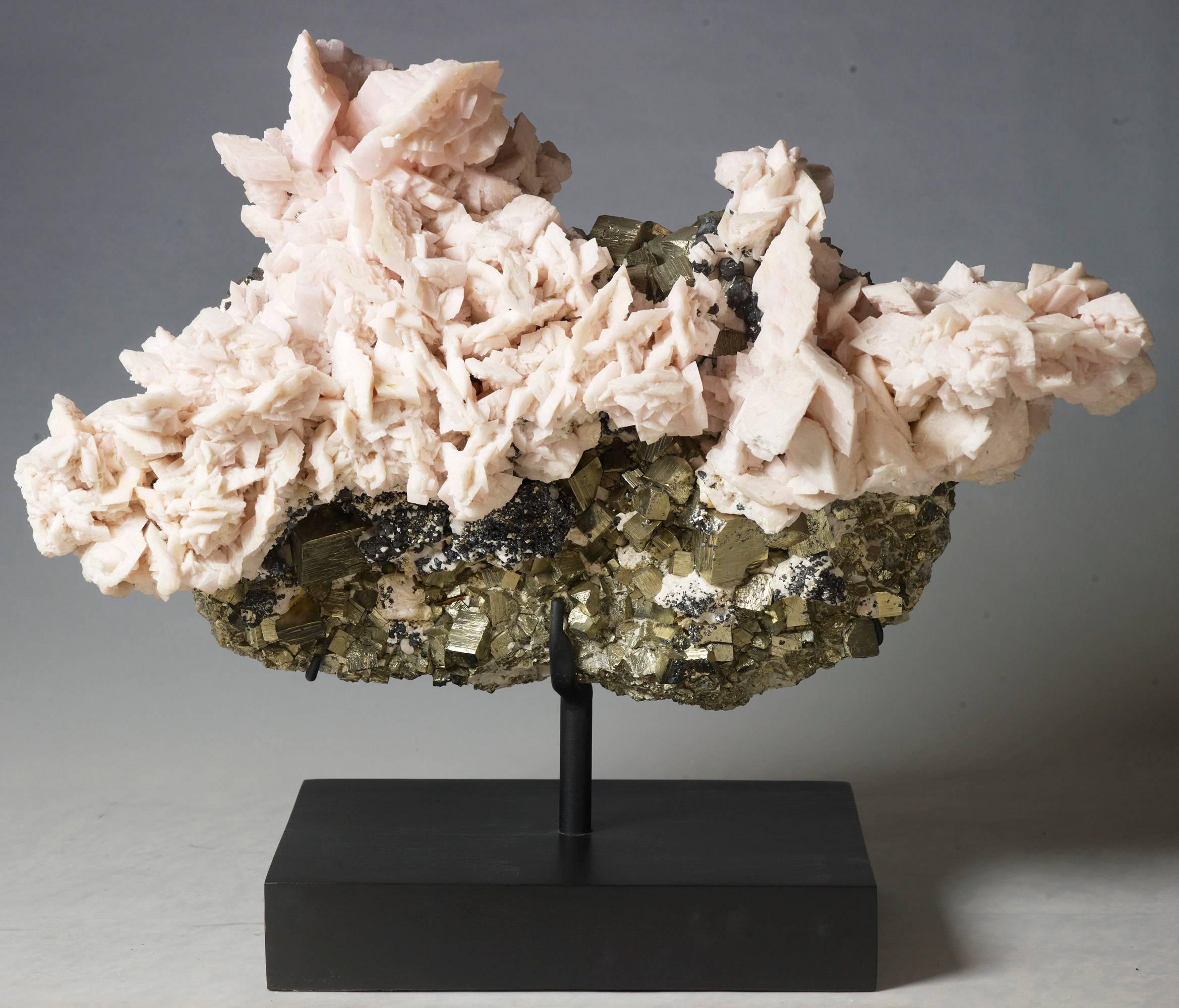 A lovely combination of manganocalcite over pyrite crystals. Measures: 56 x 64 x 24 with stand.