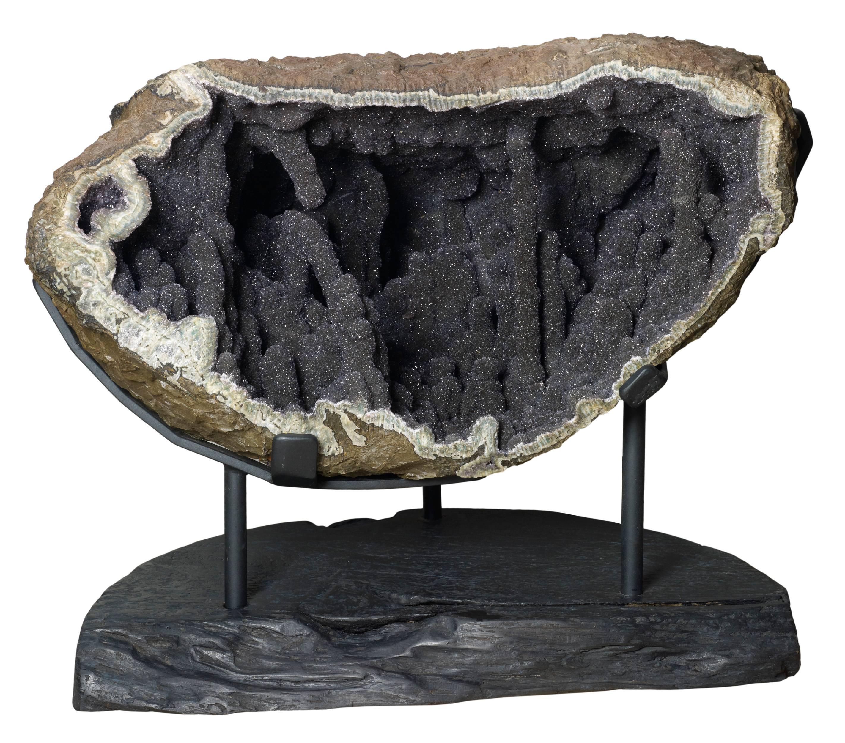 A beautiful and unique geode of stalactites of clear quartz over black jasper. Difficult to find a large one like this: Measures: 72 x 84 x 57 on a decorative stand made by hand to fit perfectly. This rare deco crystal will harmonize end embellish