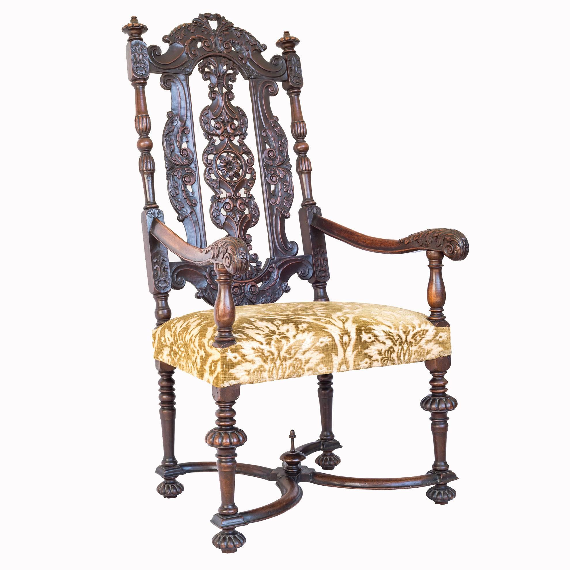 A superb late 17th century Flemish style high-back armchair in walnut, richly carved in the taste of Daniel Marot.

English, circa 1890.

The profusely carved and pierced back, acanthus leaf decorated arms, above the stuff-over seat covered in