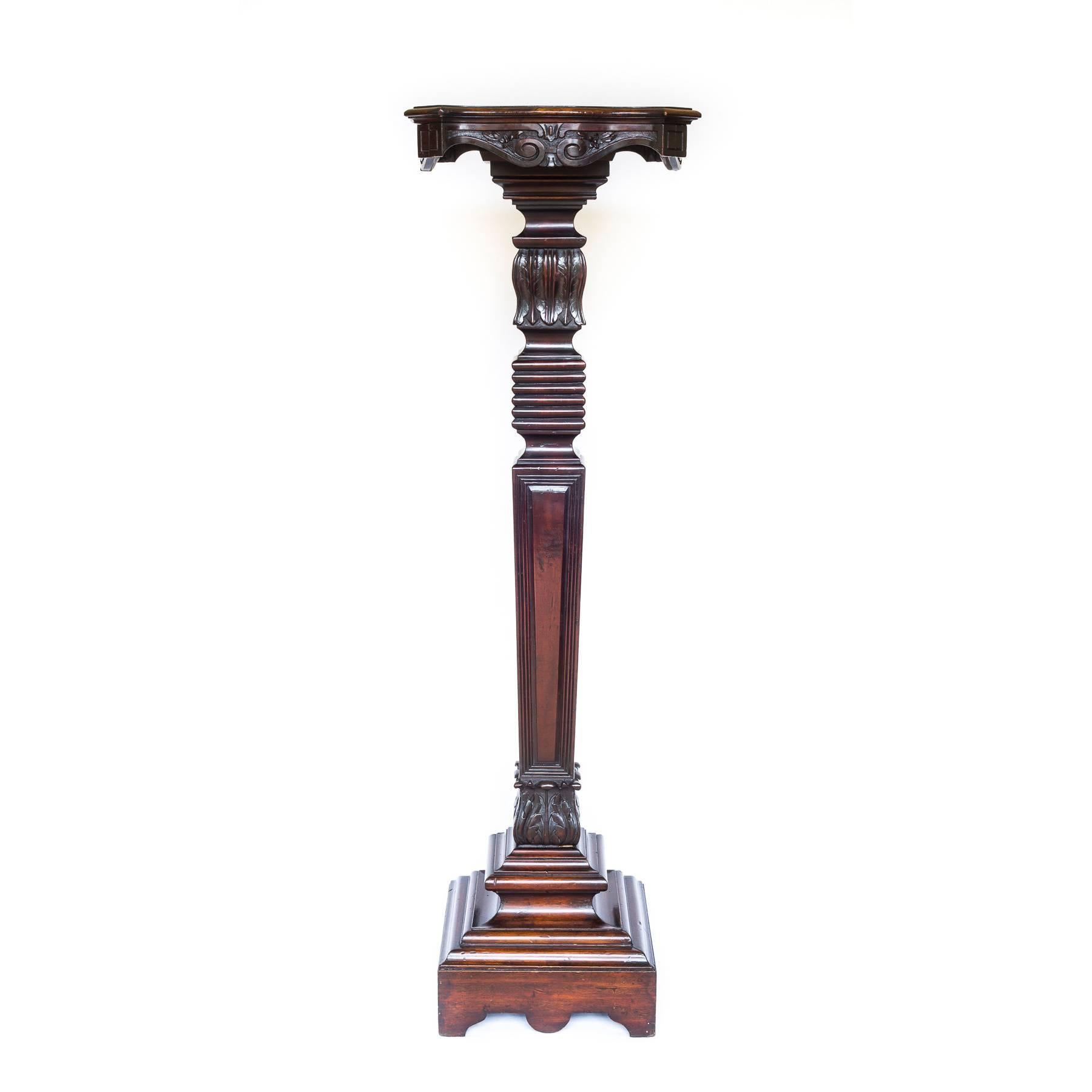 A good William IV carved mahogany pedestal, circa 1835.

The serpentine and moulded solid mahogany top, with shaped apron carved with flowers and scrolls, raised on the moulded and panelled square tapering column carved with foliage, above the