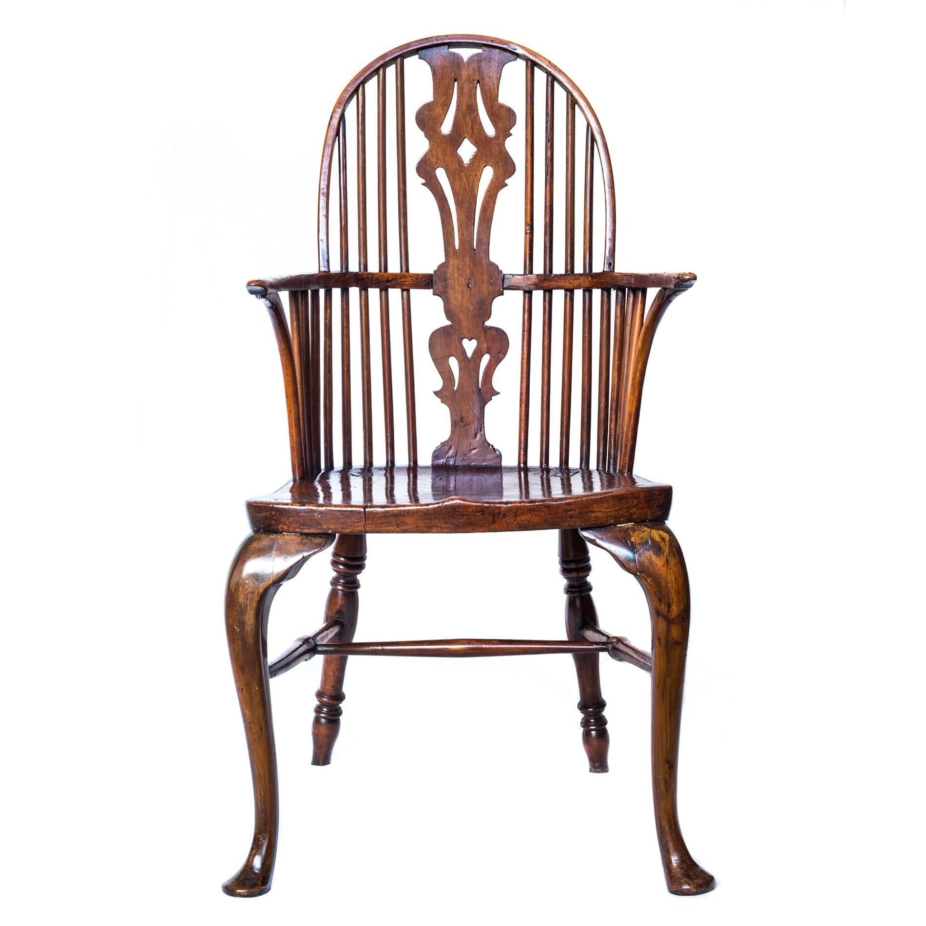 An attractive mid-18th century George III period Elm, Ash and Walnut Windsor high-back armchair.

English, Thames Valley, c. 1760

The double bow back with pierced Chippendale inspired central splat, arms with inswept front supports, over