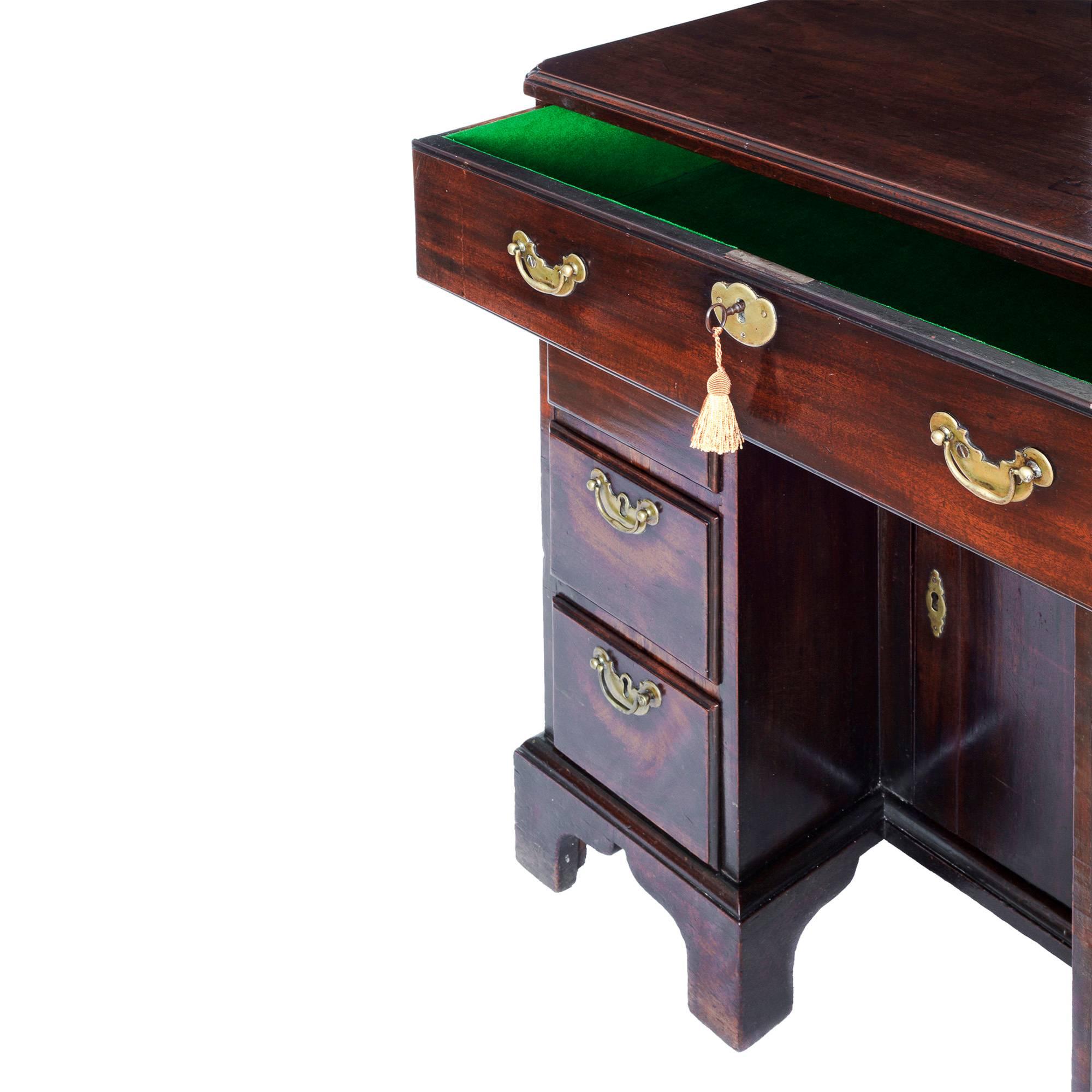 A fine mid-18th century George II period cuban mahogany kneehole desk of diminutive proportions in remarkably original condition, original surfaces, superb colour and patination.

English, circa 1750.

The moulded rectangular solid mahogany top,