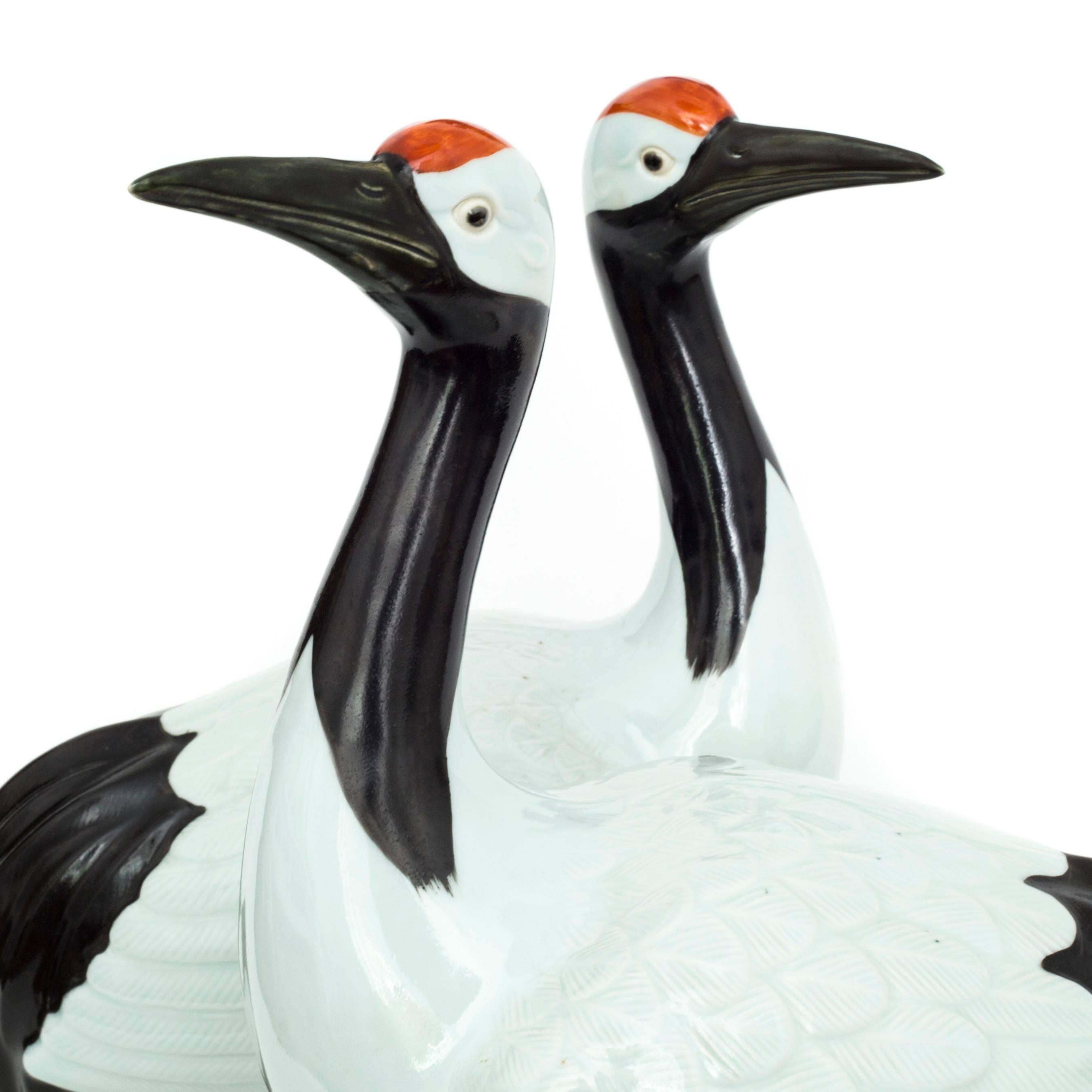 A superb, very large and rare opposing pair of porcelain figures modelled as red-crowned cranes (Grus japonensis), also called the Japanese crane,

Republic of China (1912-1949).

Finely detailed throughout, beautifully painted and glazed in various