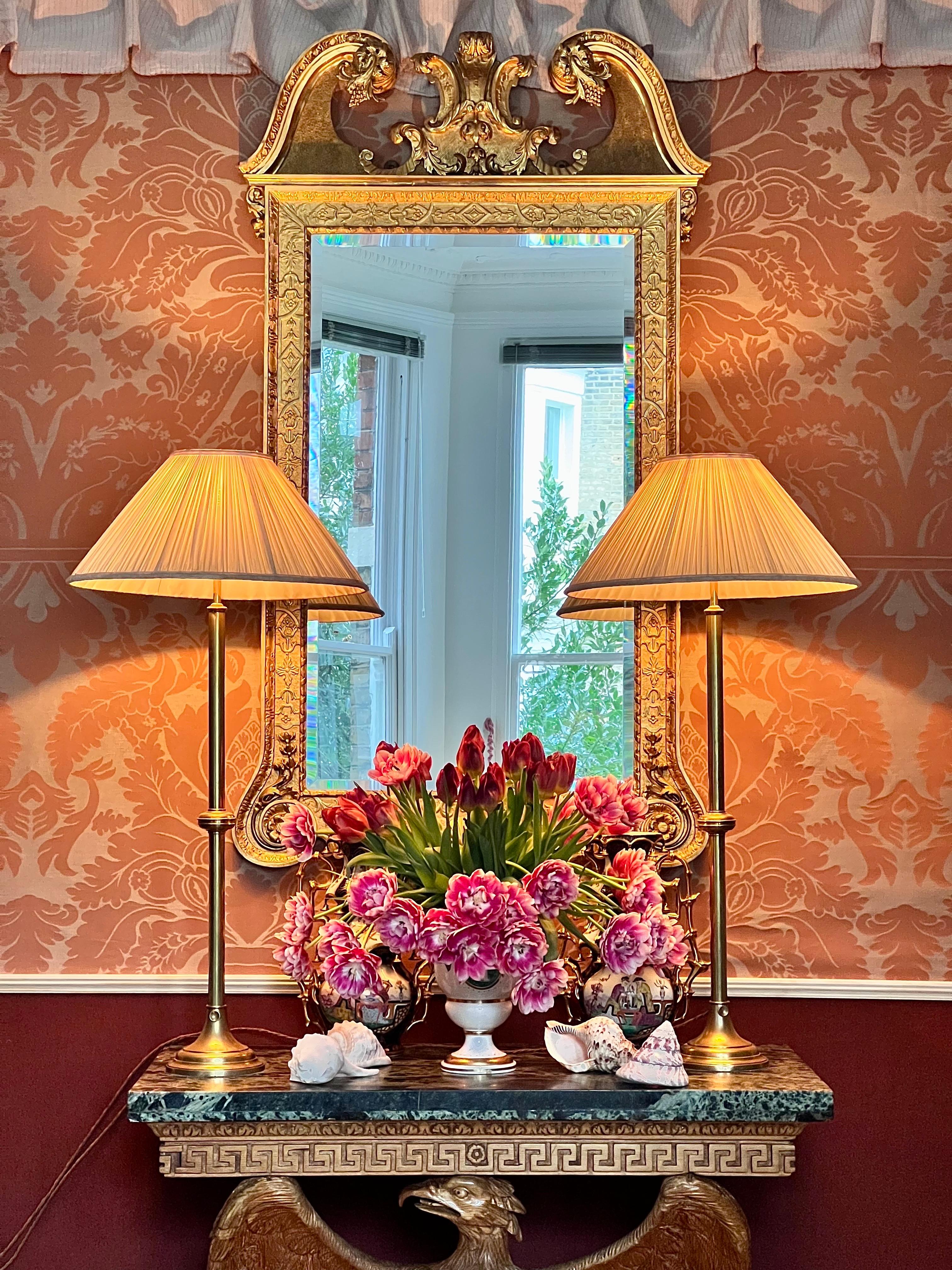 A pair of exceptionally rare and unusually tall antique brass table lamps from the 18th century. 
English, circa 1760.

Why We Like Them:

These stunning rare lamps offer a unique blend of simplicity and sophistication. The sleek, elongated stems,