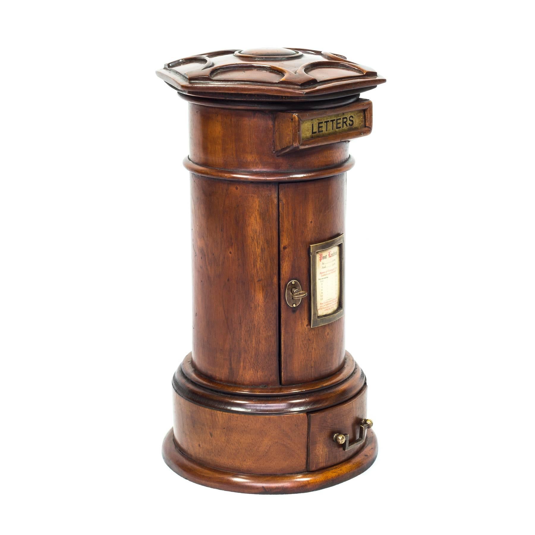An excellent quality mahogany Victorian style country house pillar post box. The hexagonal domed roof carved with adjoining half moons above each edge and with central dome, the posting slot with a brass shutter incised 'LETTERS', the locking door