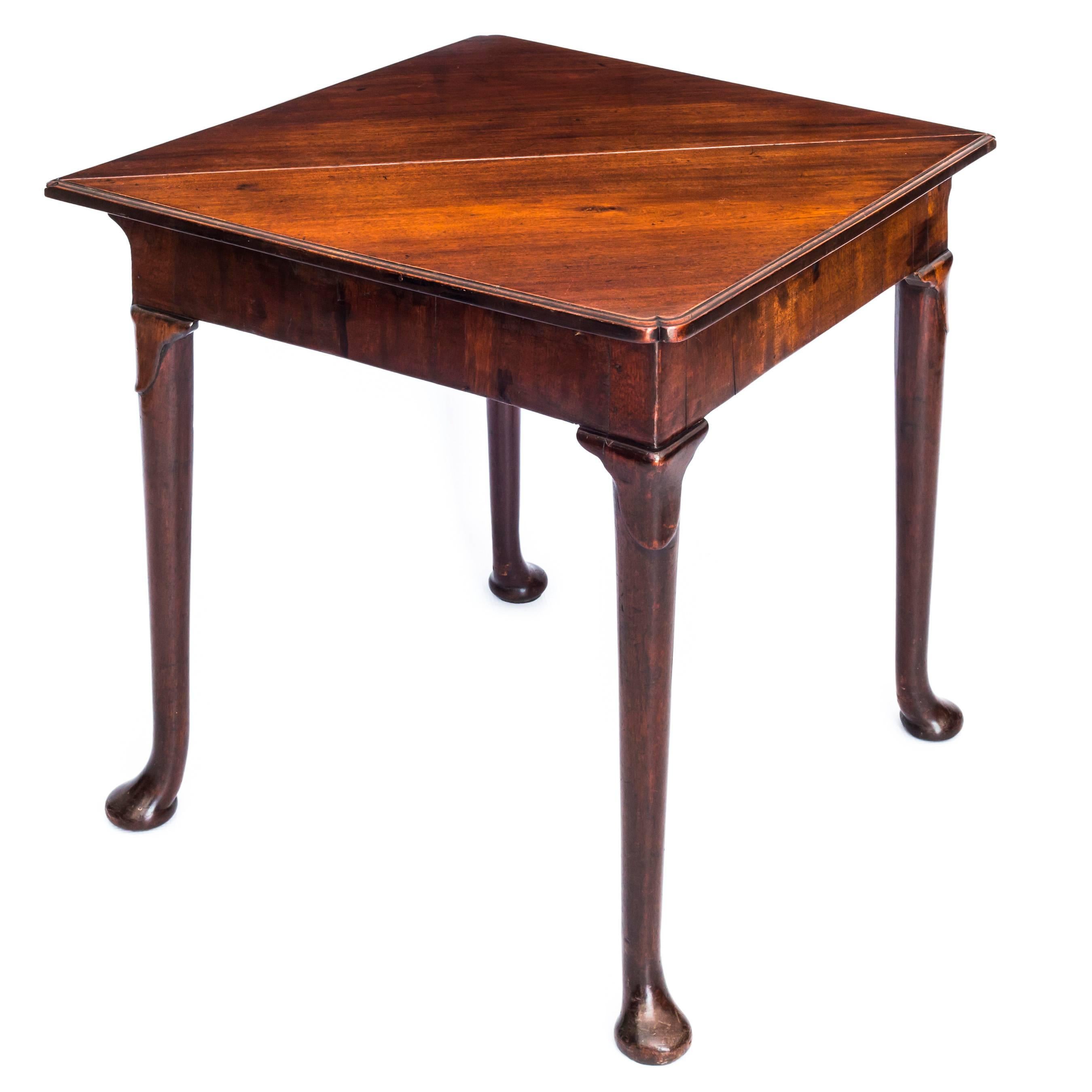 A superb mid-18th century George II period solid mahogany corner or handkerchief table, of small proportions,

English, circa 1750.

The triangular solid mahogany top, having a rear-drop leaf, with a moulded edge and re-entrant opposing corners,