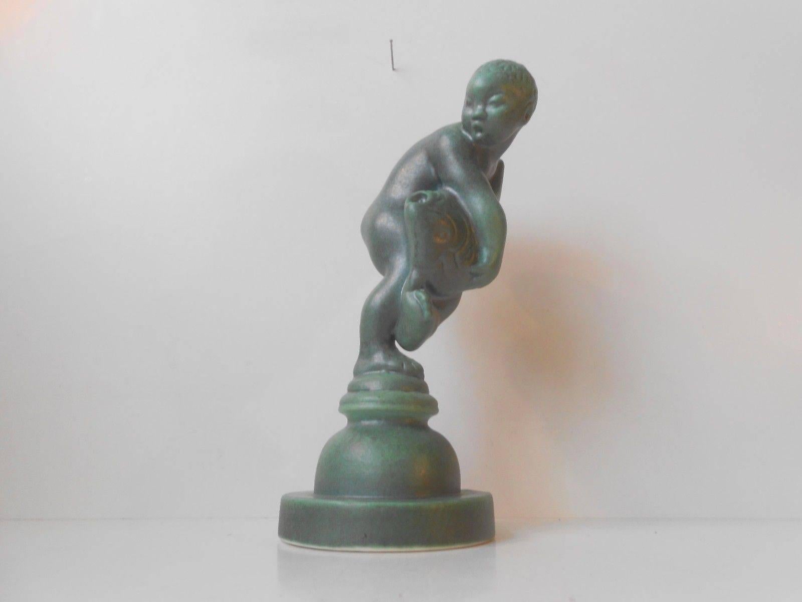 Measurements and infos:

Type: figure of boy and fish. 

Height: Approximately 21 cm (8.5 inches).

Base diameter: Approximately 9 cm (3.75 inches).

Material: terracotta with 
