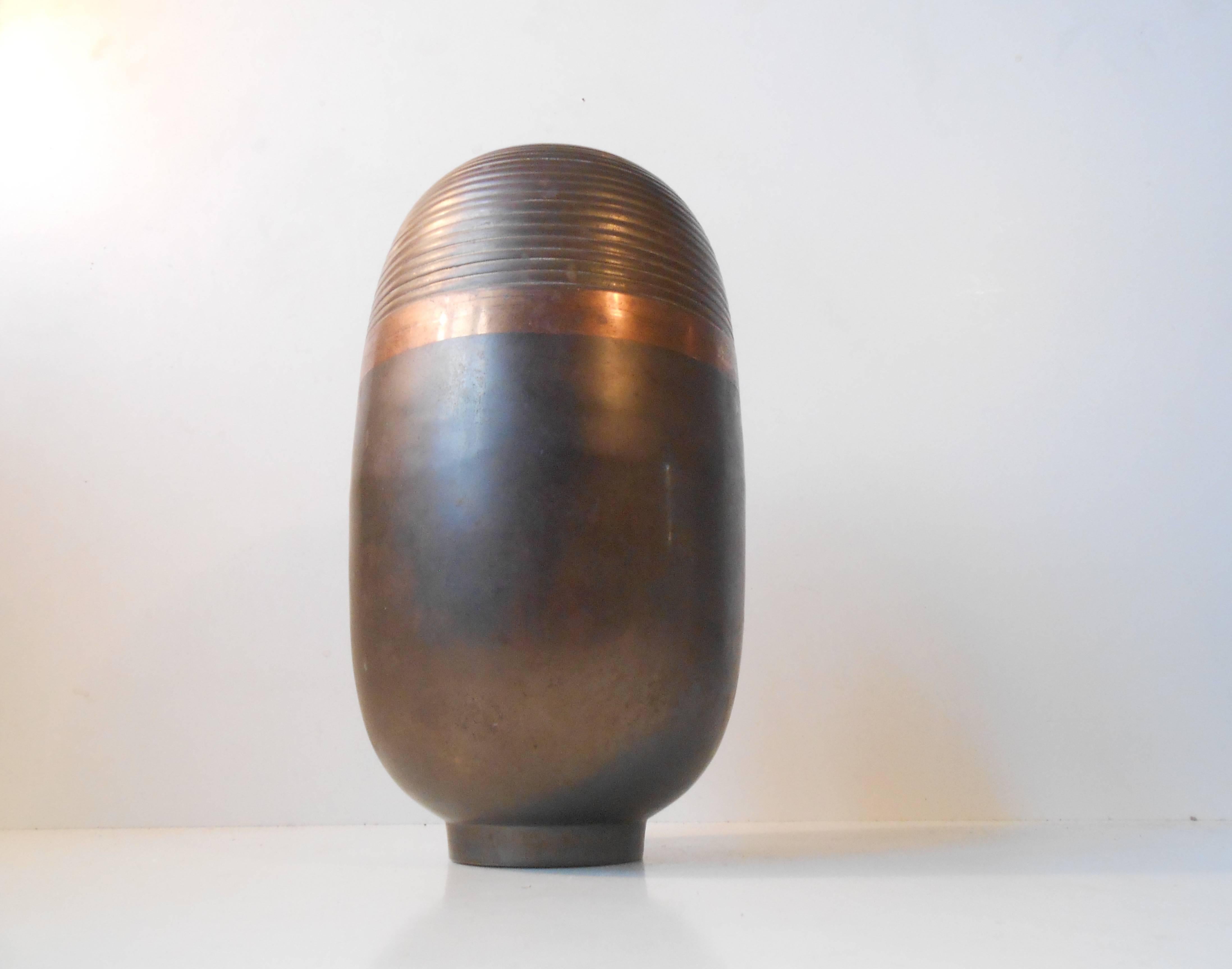 A fine French Art Deco Dinanderie vase from the 1930s in brass and copper patinated bronze. With its striking organic shape and typical Art Deco lines, the vase is a Classic example of modern French metalwork. The vase is 9” tall and unsigned.
Have