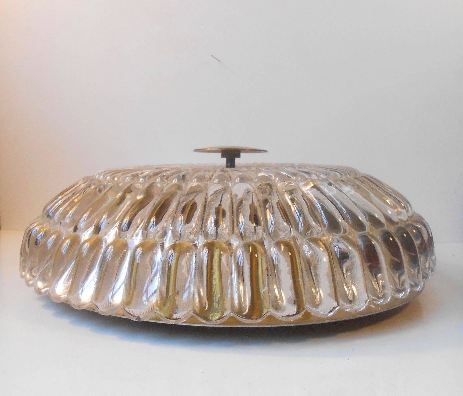 Info and measurements:

Type: Crystal and brass flush mount ceiling chandelier.

Designer: Carl Fagerlund.

Manufacturer: Orrefors.

Origin: Sweden.

Period: Early part of the 1950s.

Diameter: Approximately 40 cm (16 inches).

Depth: