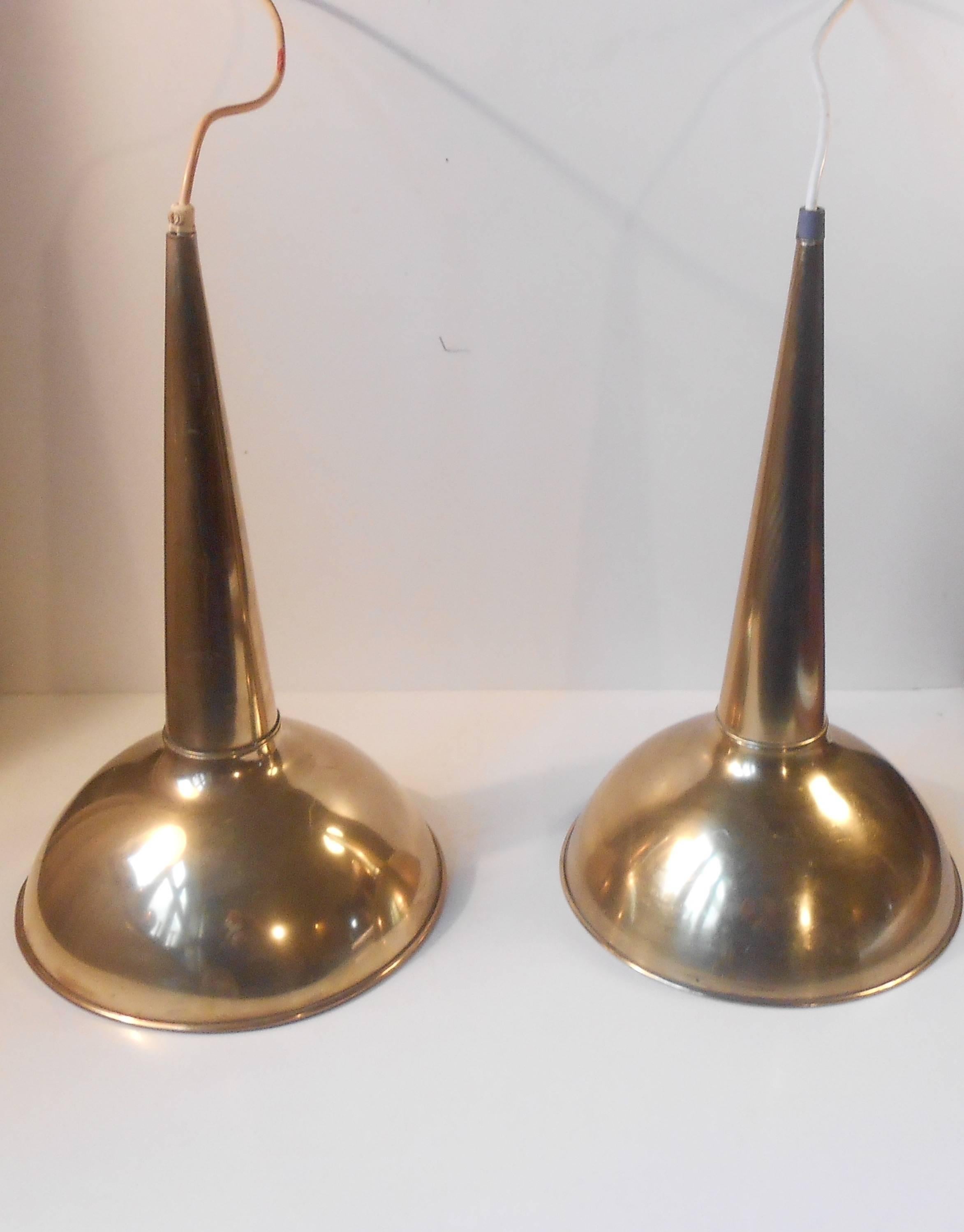 Monumental and rare pair of trumpet-shaped pendant lights by anonymous scandinavian maker/designer, circa 1960. Composed of solid polished brass these lights demands attention. Measurements: D 10 inches (25 cm), H 17 inches (43 cm). They will be