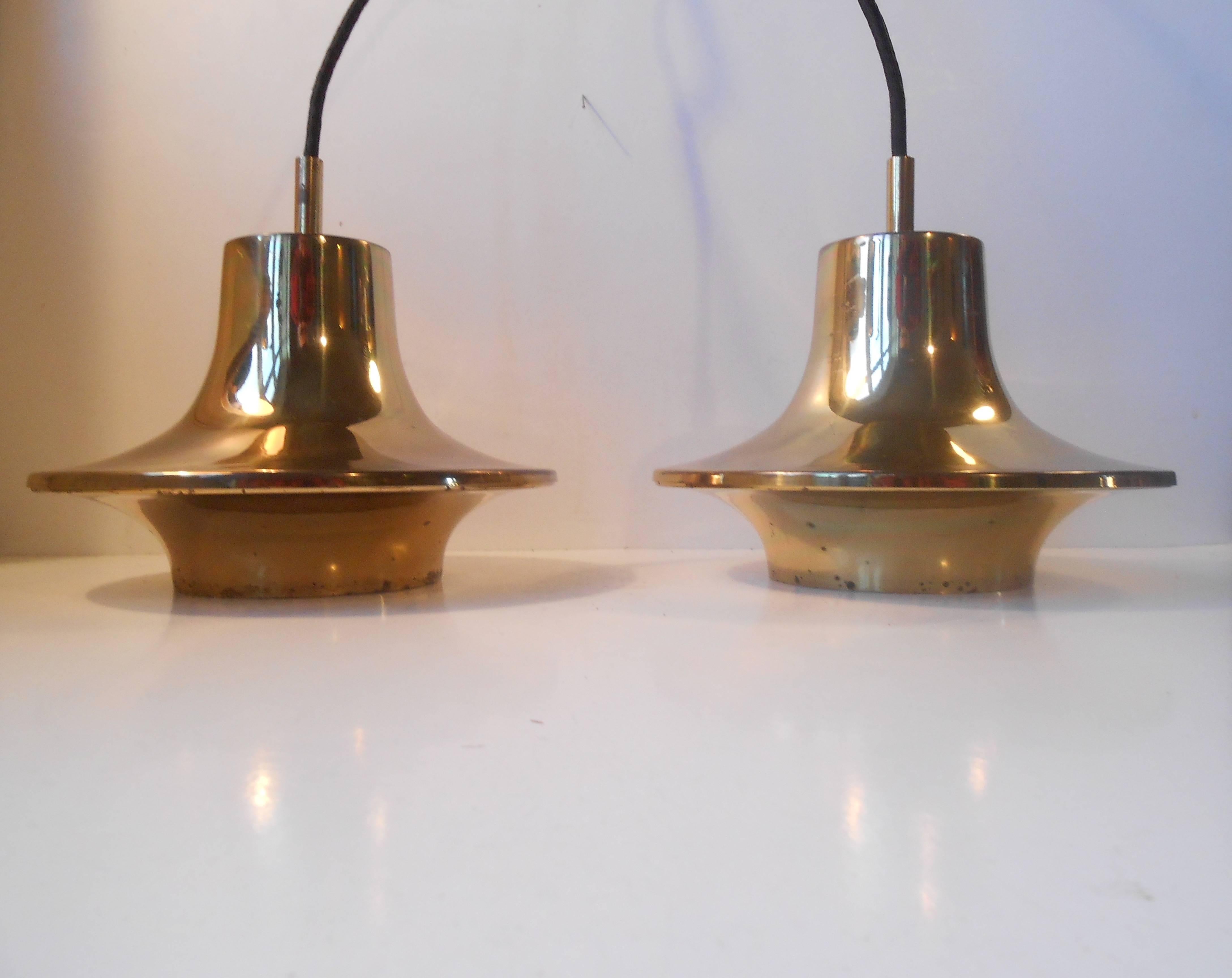 Rare pair of solid pendant ceiling lights by Hans-Agne Jakobsson for Markaryd Sweden, 1960s. Distinct saucer shapes with patina to the brass. Suitable for kitchen, cosy corner lightning, over your mid century desk or sideboard. The price is for the