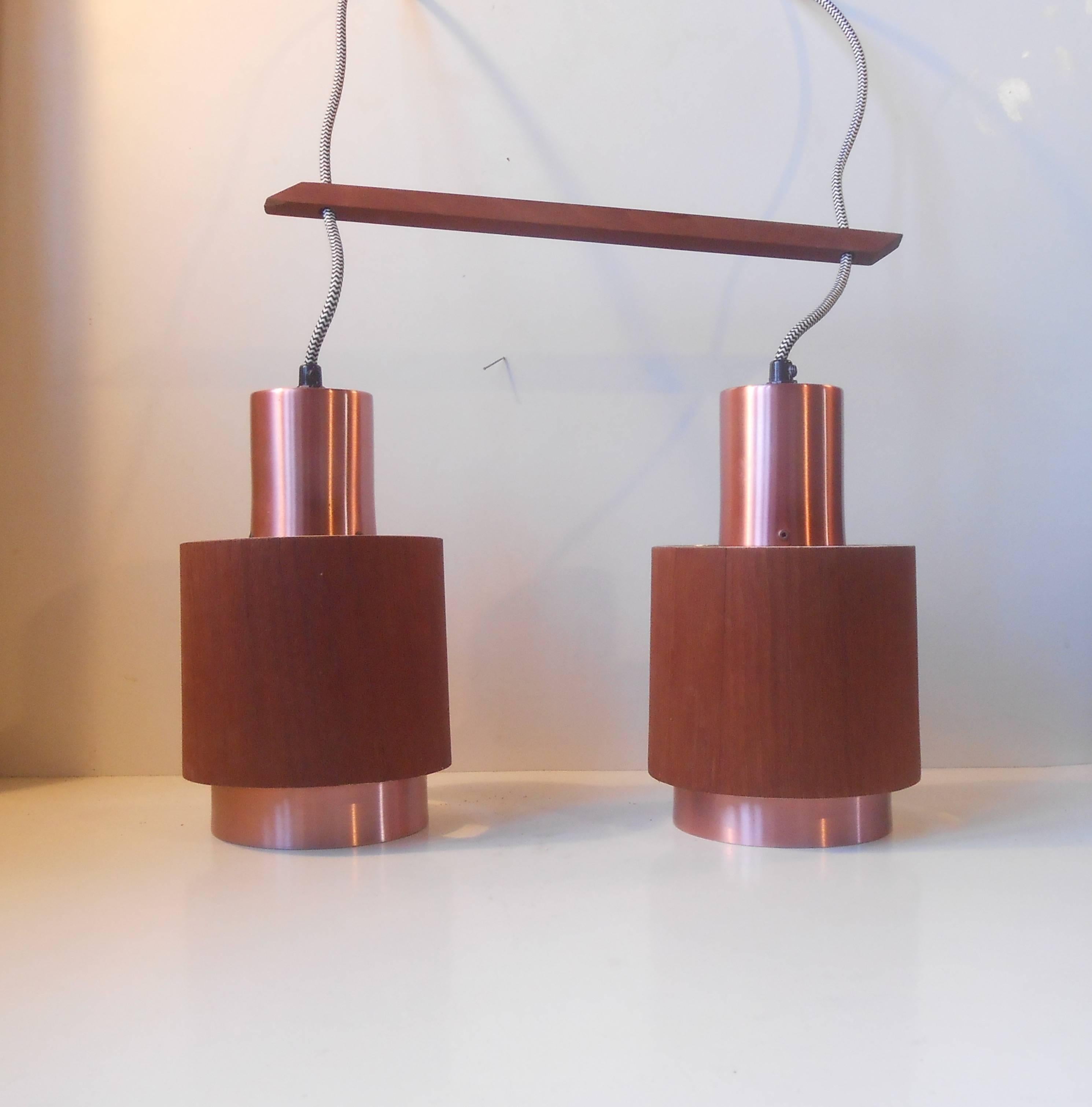 Stylish two-shaded adjustable pendant lamp with genuine teak veneer and rosé toned copper alloy to the aluminium based shades. Width in total: 14 inches, height: adjustable, individual shade diameter: 6 inches.
Please have a look at my other
