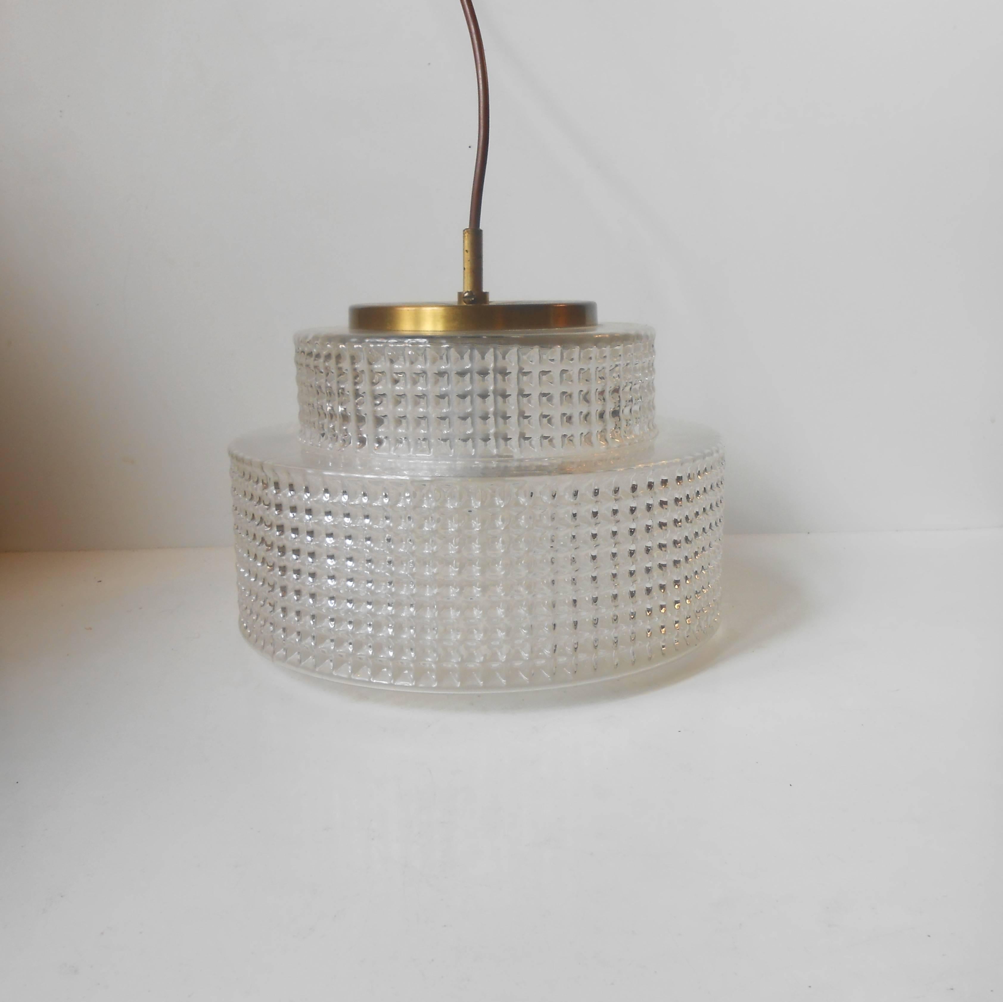 Clear diamond-pattern glass og slightly patinated perforated brass makes this pendant light by Vitrika Denmark stand out in any interior as a beautiful and pure 'piece of Scandinavia'. The lamp, as all of my other is shipped in working condition