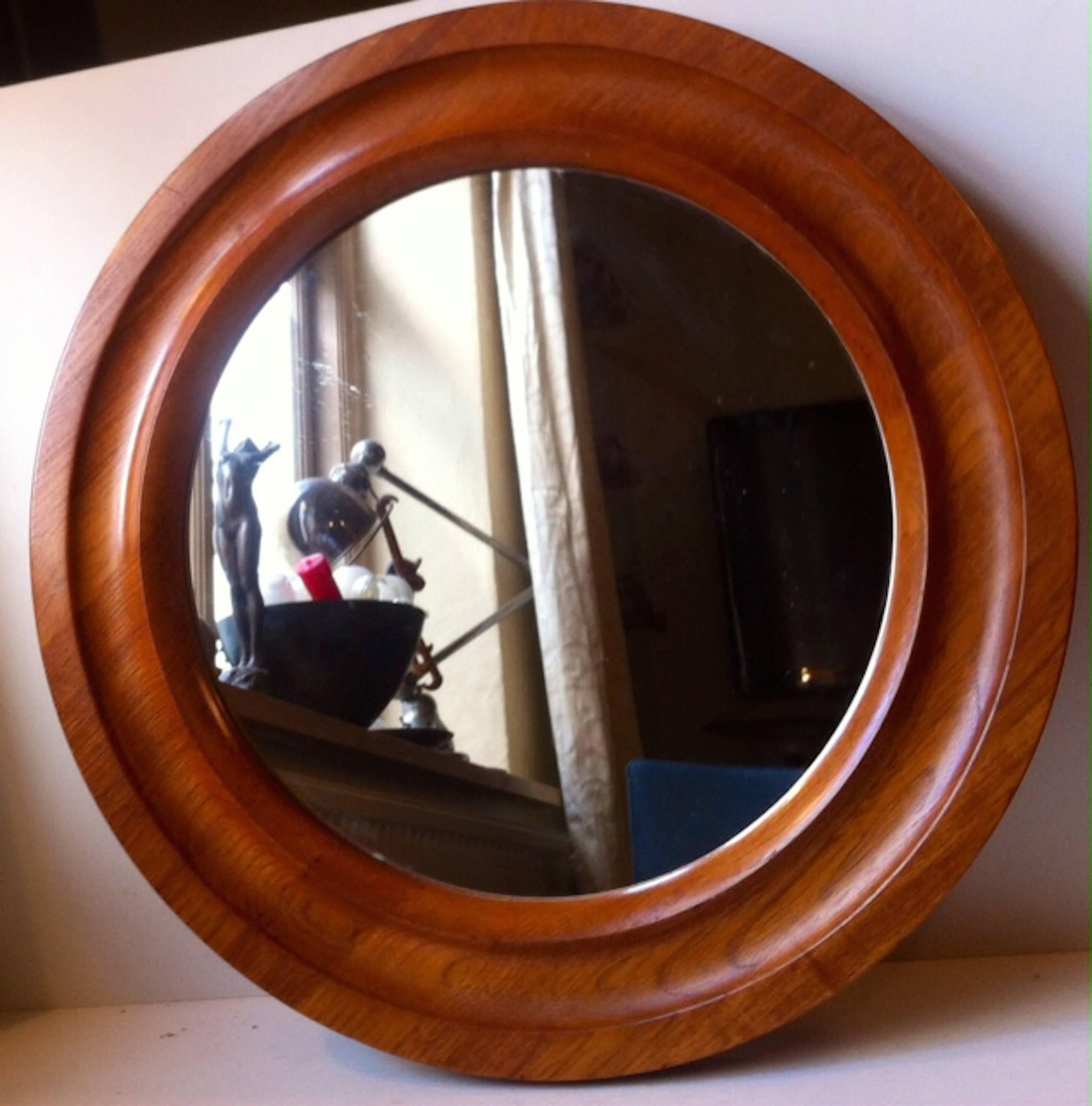 Round wall-mounted mirror in tapered teak by Pedersen and Hansen. Measurements: D: 20 inches (50 cm). Stamped: Made in Denmark.