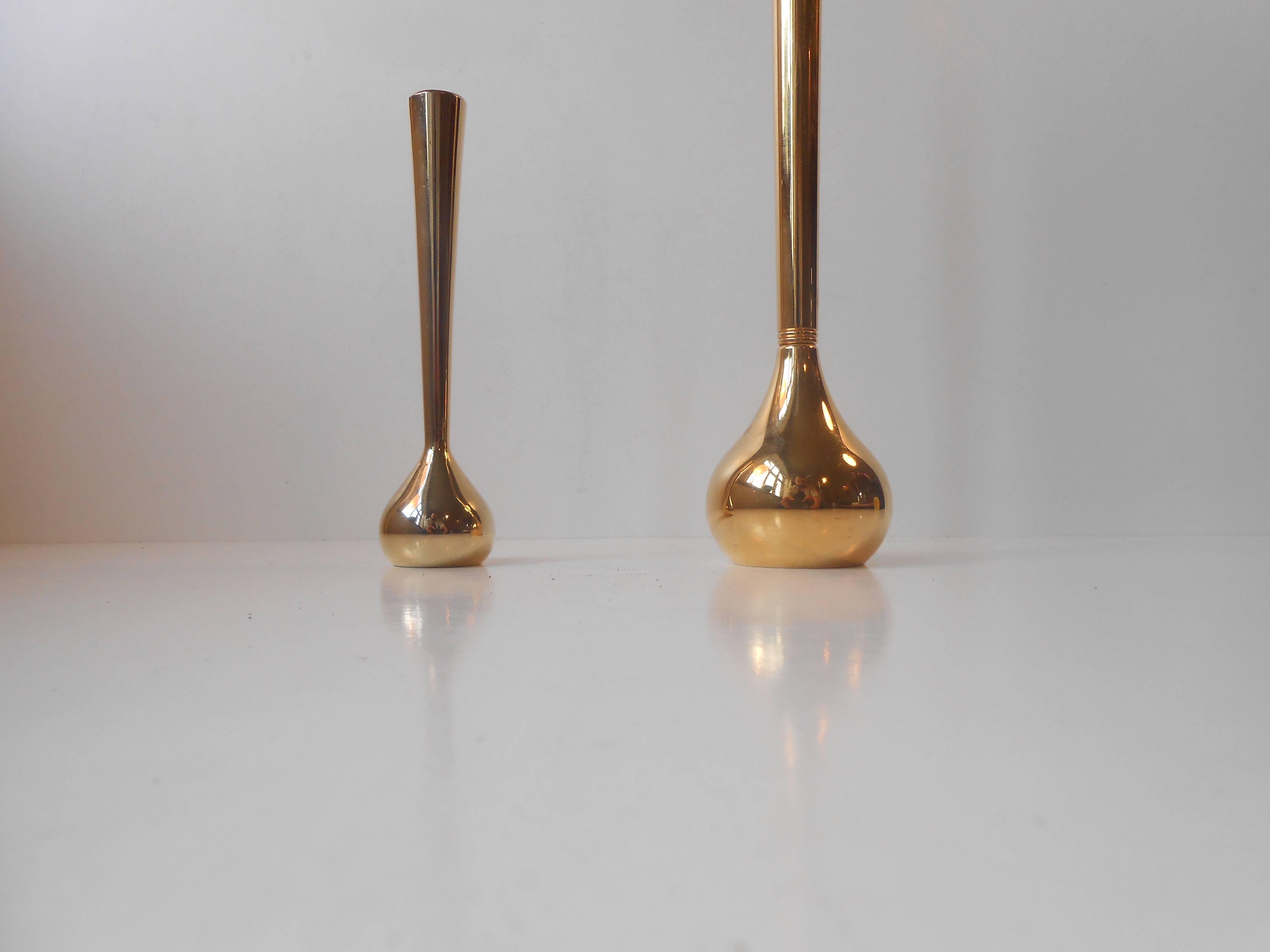 A series of heavily gilded Mid-Century Modern candlesticks and vases was designed by Hugo Asmussen in the early 1960s. Stamped to the bottom of each vase: Design Asmussen, 24-carat gold plating, made in Denmark. Measurements: H: 5.8/10.5 inches