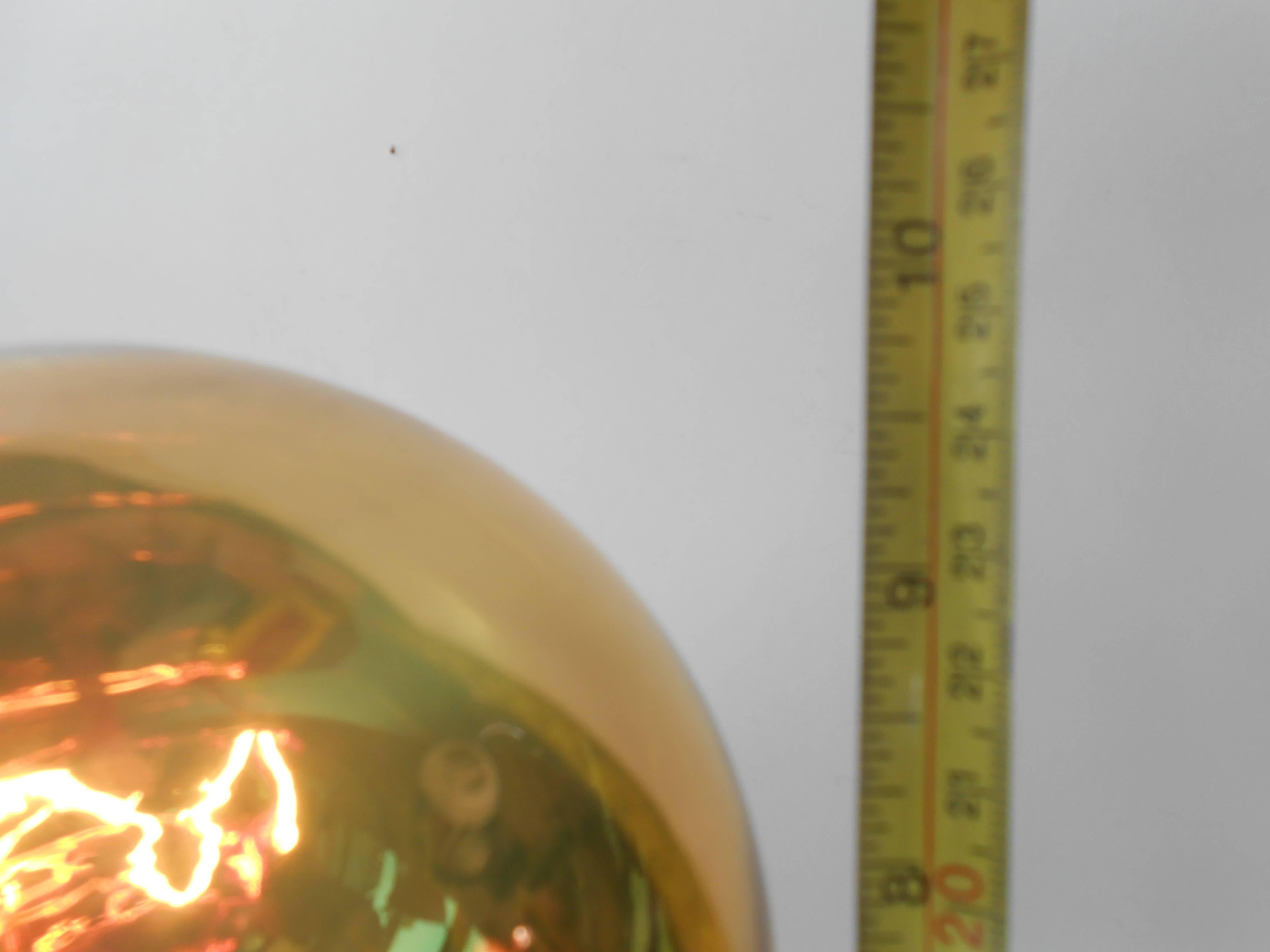 This 'Spy Ball' table lamp was produced in the early 1970s by the Danish Design-Company Frimann. Featuring a Philips Goldstar 126 everlasting Bulb, the golden bulb reflects its surroundings when unlit, hence the name 'Spy Ball'.