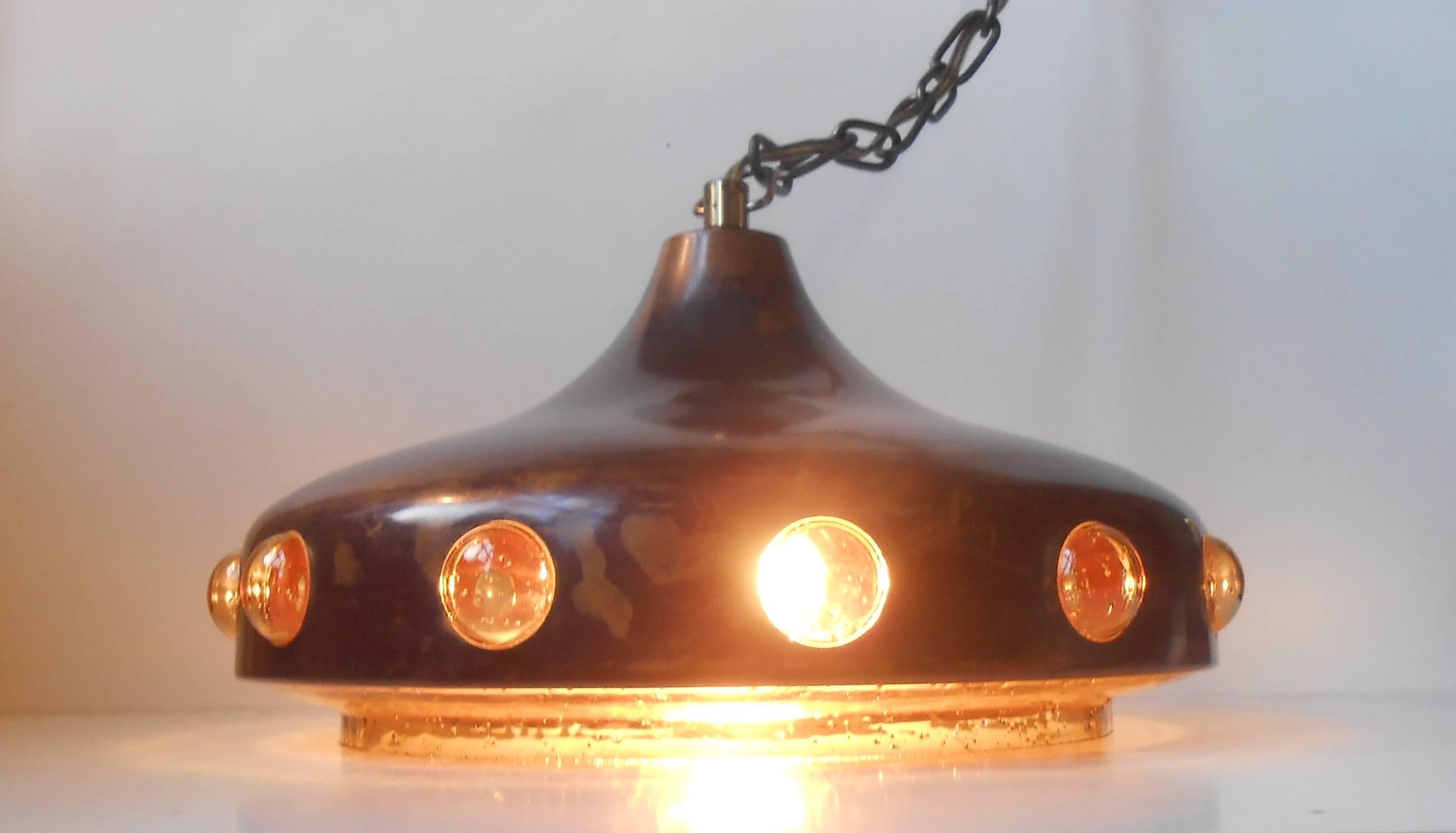 A Mid-Century classic by one of the important modern finnish designers. Nanny Still designed for RAAK in the 1960s. Acid Threated copper outer-shade lined with amber handblown glass. Original brass chain and ceiling cover/can are included in the