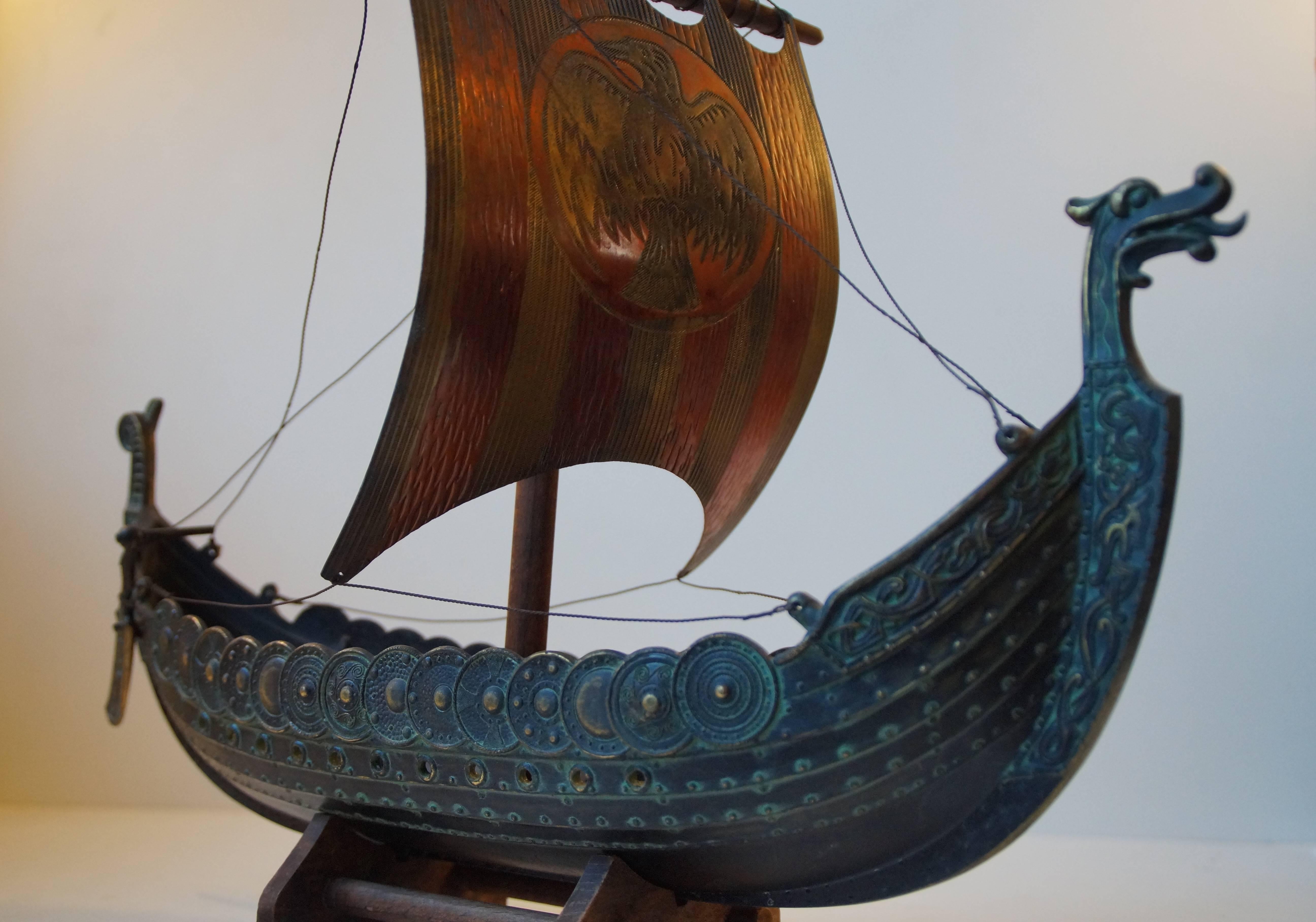 Beautifully crafted and detailed model of Viking Ship in patinated bronze by Edward Aagaard for Copenhagen Iron Art. Intact and complete condition and with a small wooden stand for display in your office or gents room. Stamped: Copenhagen Iron Art