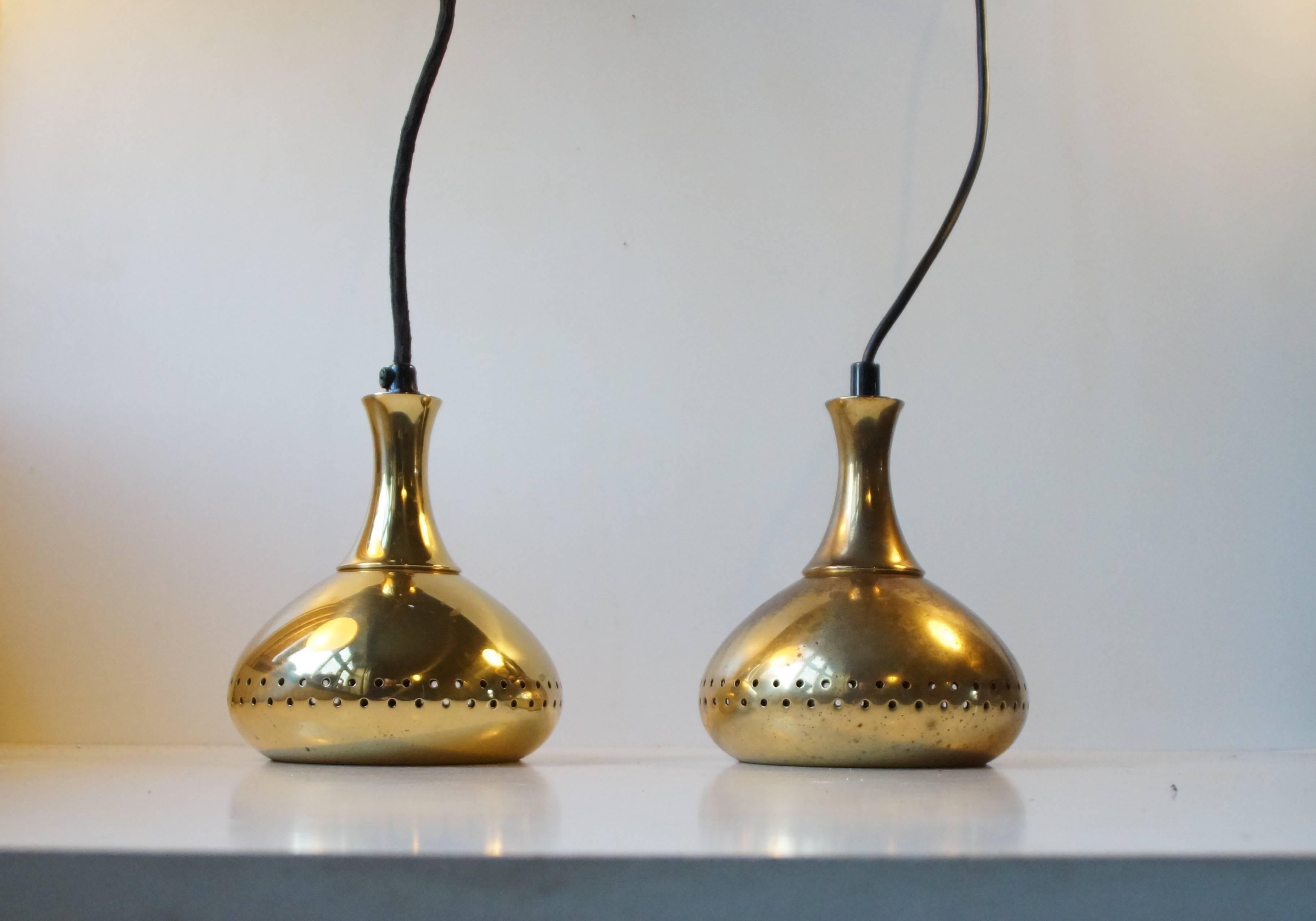A pair of small pendants in partially perforated brass designed by Hans-Agne Jakobsson and manufactured by Markaryd AB in Sweden during the 1950s. Very nice vintage condition - one slightly more patinated than the other. The lamps comes with new