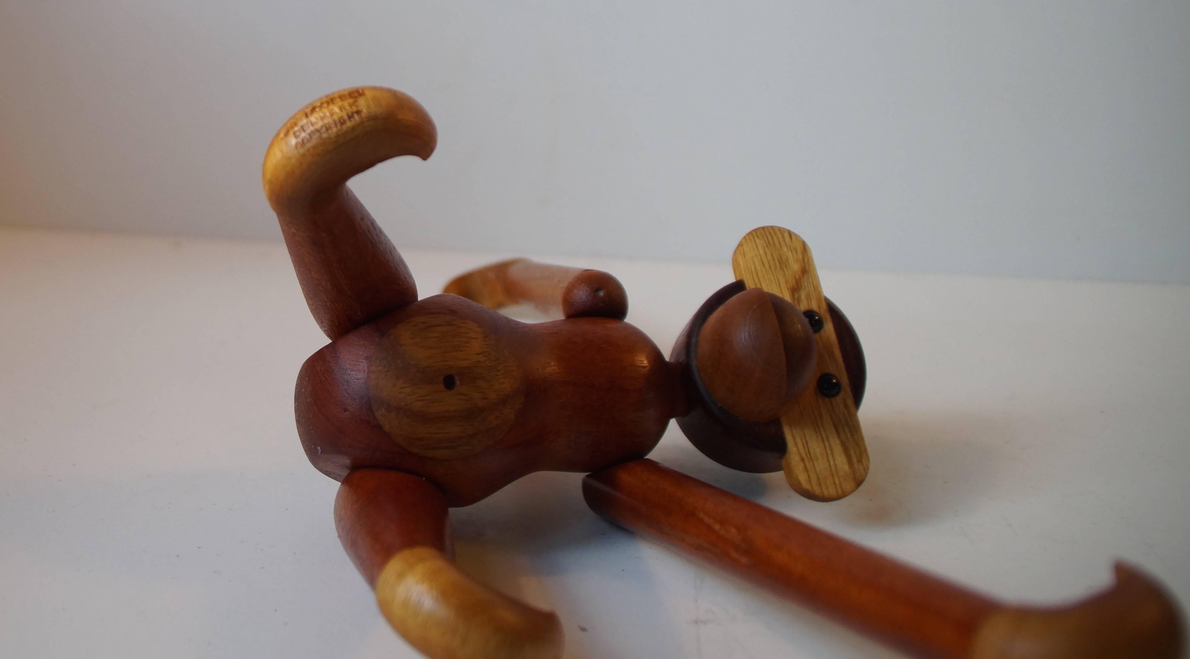 Iconic articulated teak and limba monkey designed by Kay Bojesen, Denmark. This is an example from the 1960s. Very good vintage condition with a beautiful and rich character adding Patina. Signed to one foot!