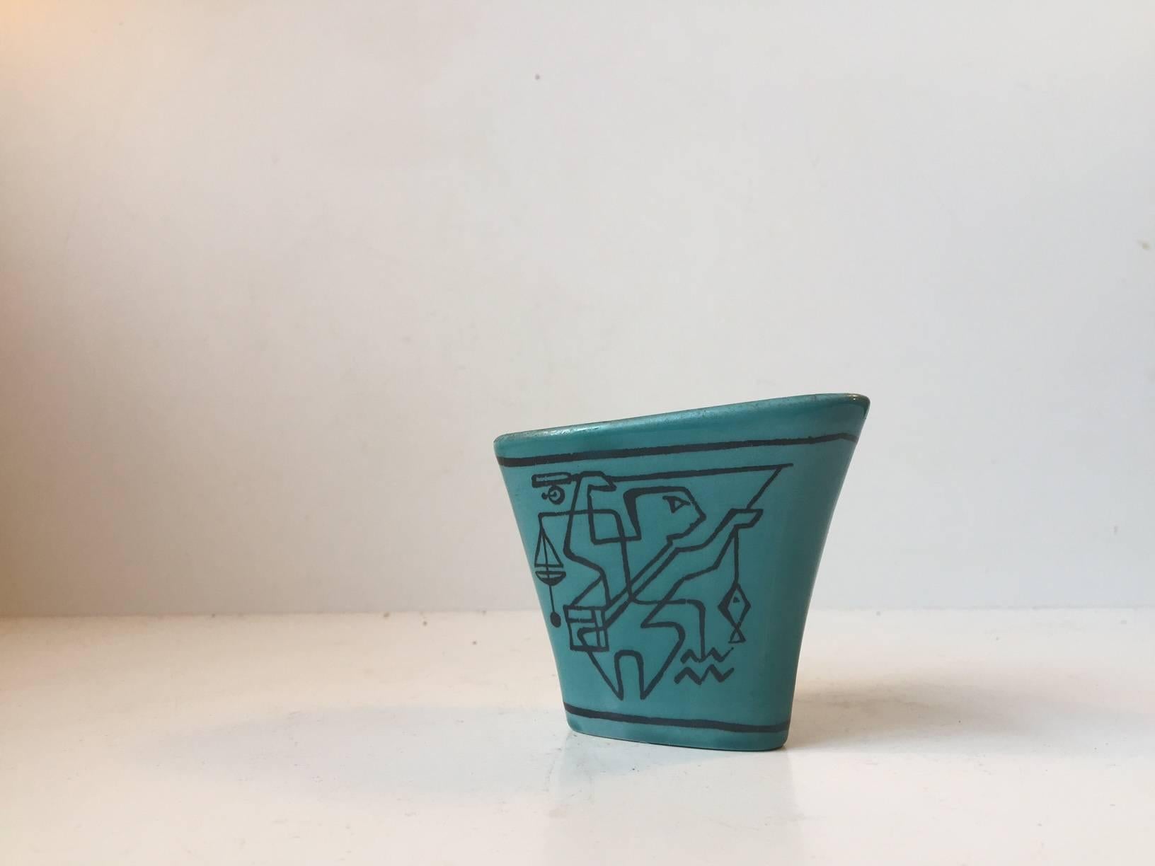 This Turquoise Unika vase was designed by Gunnar Nylund. It has two different sides each with handmade Avant-Garde motifs inspired by the Danish Cobra Movement and Picasso. The vase features Nylund's signature and the manufacturer's mark.
