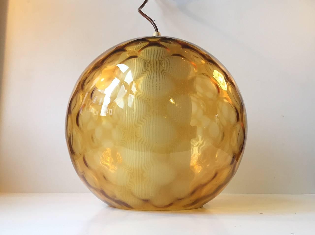 This Pendant was designed by Wilhelm Wagenfeld and manufactured by Peill & Putzler in Germany during the 1950s. It features an exterior optical glass dome, milky horizontally striped opaline inner-shade and original brass ceiling cover and
