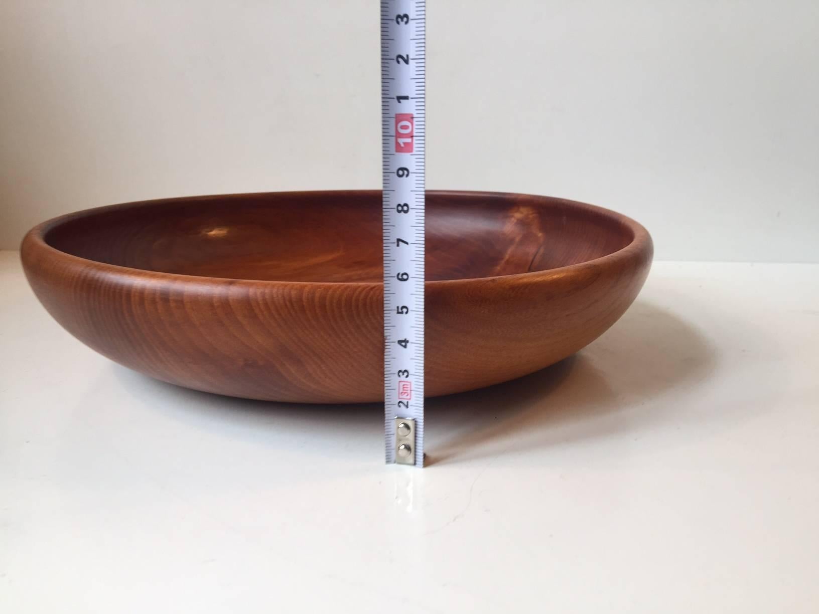 Handmade bowl of solid Siamese teak with emphasis on the beautiful grains. Manufactured and designed by Kay Bojesen in his workshop in Copenhagen during the 1950s. It is stamped Kay Bojesen, Mønsterbeskyttet (patented), Denmark.